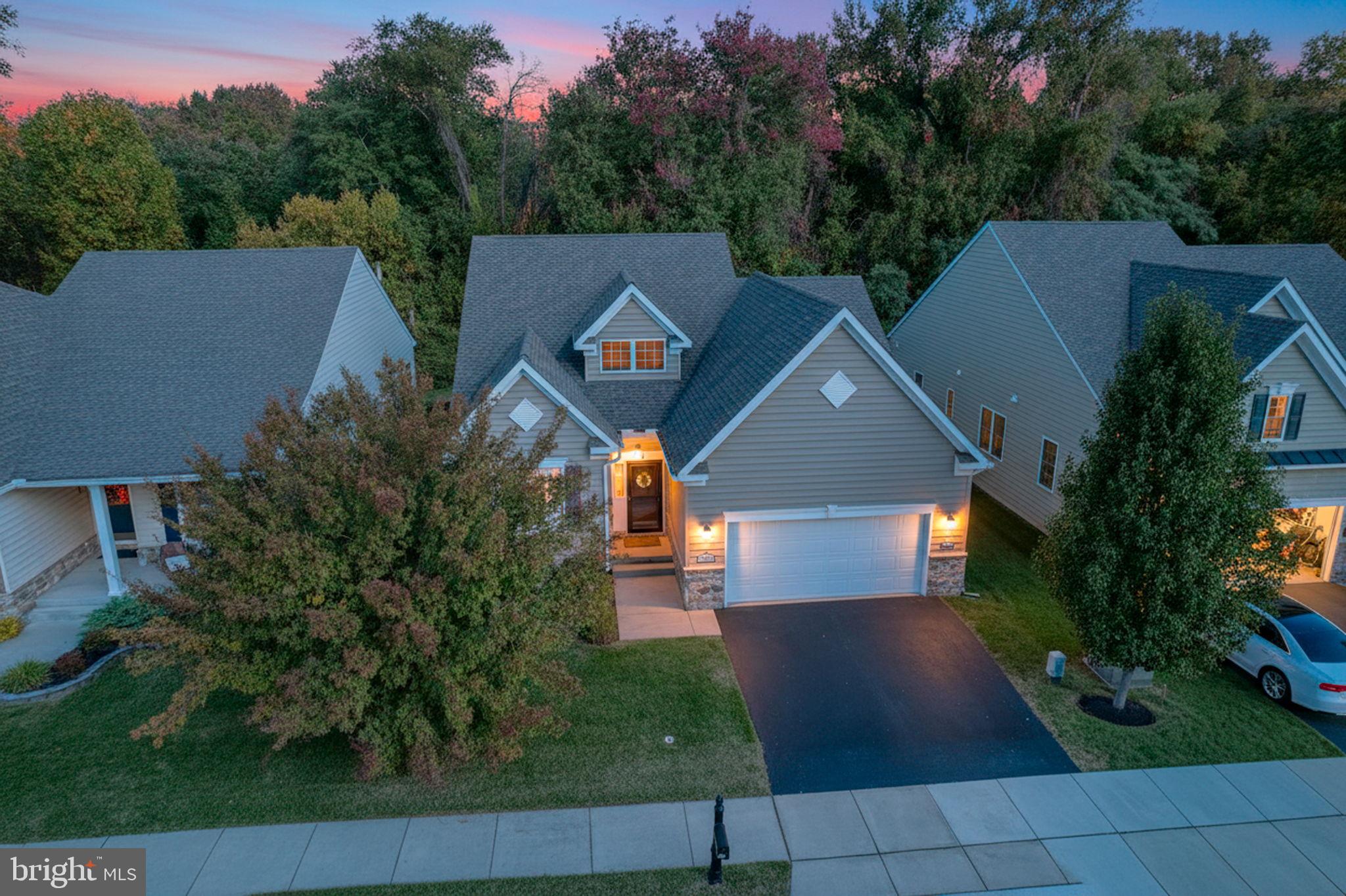 Situated against protected woodlands in the highly desirable Village of Eastridge, this beautifully maintained Bayard model offers comfort, privacy, and carefree 55+ living. Imagine starting your morning with coffee overlooking the trees, enjoying the peace and quiet of a premium lot with no rear neighbors, then spending the afternoon with friends at the clubhouse, on the walking trails, or simply relaxing at home knowing the lawn care and snow removal are already taken care of. 
Designed with easy living in mind, this spacious home offers over 2,300 square feet of flexible living space, including a first-floor primary suite, a second bedroom and full bath for guests, an office or third bedroom AND an expansive loft that can serve as a home gym, hobby space, media room, or potential fourth bedroom. Cathedral ceilings, hardwood floors, and an open-concept layout create a bright and welcoming atmosphere throughout. The kitchen is the heart of the home, featuring granite countertops, 42-inch maple cabinetry, stainless steel appliances, a double oven, and a large center island perfect for gathering with family and friends. One of the standout features of this home is the abundance of storage, a rarity in many active adult communities. The oversized loft walk-in closet and additional crawlspace storage provide plenty of room for seasonal décor, keepsakes, and everything you want to keep without sacrificing living space. 
Outside your door, enjoy all that Village of Eastridge has to offer, including a clubhouse, fitness center, walking trails, bocce courts, shuffleboard, billiards, picnic areas, and a full calendar of social activities. With a low HOA fee of just $140 per month covering lawn care and snow removal of streets, sidewalks, and driveways, you’ll have more time to enjoy the lifestyle you’ve worked so hard to achieve. Move right in and start enjoying the next chapter. No projects. No upgrades. Just easy living in a community you’ll be proud to call home.