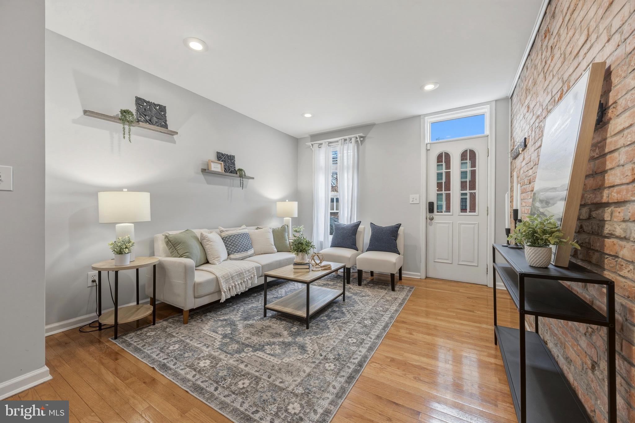 Welcome to this thoughtfully updated Locust Point rowhome, perfectly positioned to enjoy one of Baltimore’s most walkable and close-knit neighborhoods. The main level features an open-concept layout ideal for both everyday living and entertaining, with contemporary updates throughout and a convenient half bathroom. Natural light fills the living space, enhanced by upgraded recessed lighting that creates a warm, inviting feel.Upstairs, two spacious bedrooms offer comfort and flexibility. The rear bedroom functions as a true primary suite, featuring deck access, an upgraded closet, and a fully renovated en-suite bathroom with modern finishes. The front bedroom stands out with vaulted ceilings and two large windows, while a well-appointed full hall bath serves guests or the secondary bedroom with ease.The finished basement provides valuable bonus space, ideal for a home office, guest suite, or additional living area. Rounding out the home is a rooftop deck installed in 2022, offering the perfect setting for morning coffee, evening sunsets, or entertaining after a stroll to Fort McHenry, the waterfront promenade, or one of Locust Point’s beloved neighborhood restaurants.