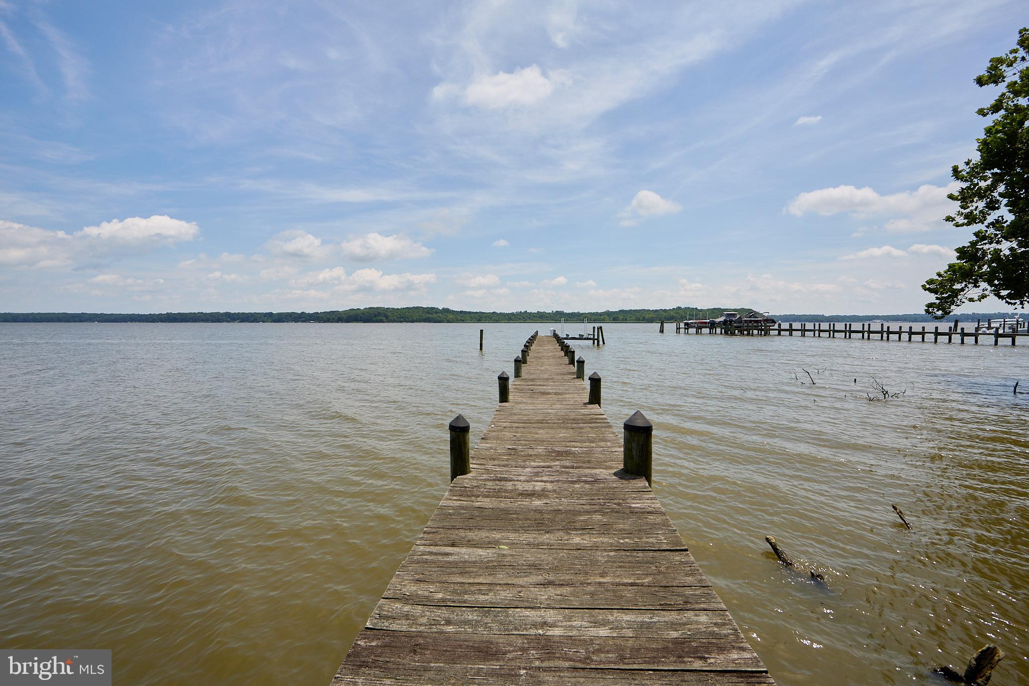 GREAT NEW PRICE!!! MOTIVATED SELLER ALERT!!!!   Location, Location, Location!
Welcome to your waterfront paradise—2.5 stunning acres on the Elk River with unmatched views and endless potential! Start your mornings with breathtaking sunrises from the deck, relax on your private beach at low tide, or head out on the water from your private dock—perfect for boating, jet skis, and exploring the Chesapeake Bay.  This 5-bedroom, 2-bath home offers a spacious open floor plan centered around a massive great room with floor-to-ceiling brick fireplace and panoramic river views. The primary suite features an en-suite bath and walk-in closet, while four additional bedrooms provide plenty of space for family or guests.  The lower level is unfinished, ready for your custom design. Two bookend garages frame the home, leading into a central walkout entertainment area—a rare and versatile layout.  This home needs your personal touch, but once complete, it will be a true masterpiece on the water.
Don't miss this once-in-a-lifetime opportunity to create your dream waterfront retreat!