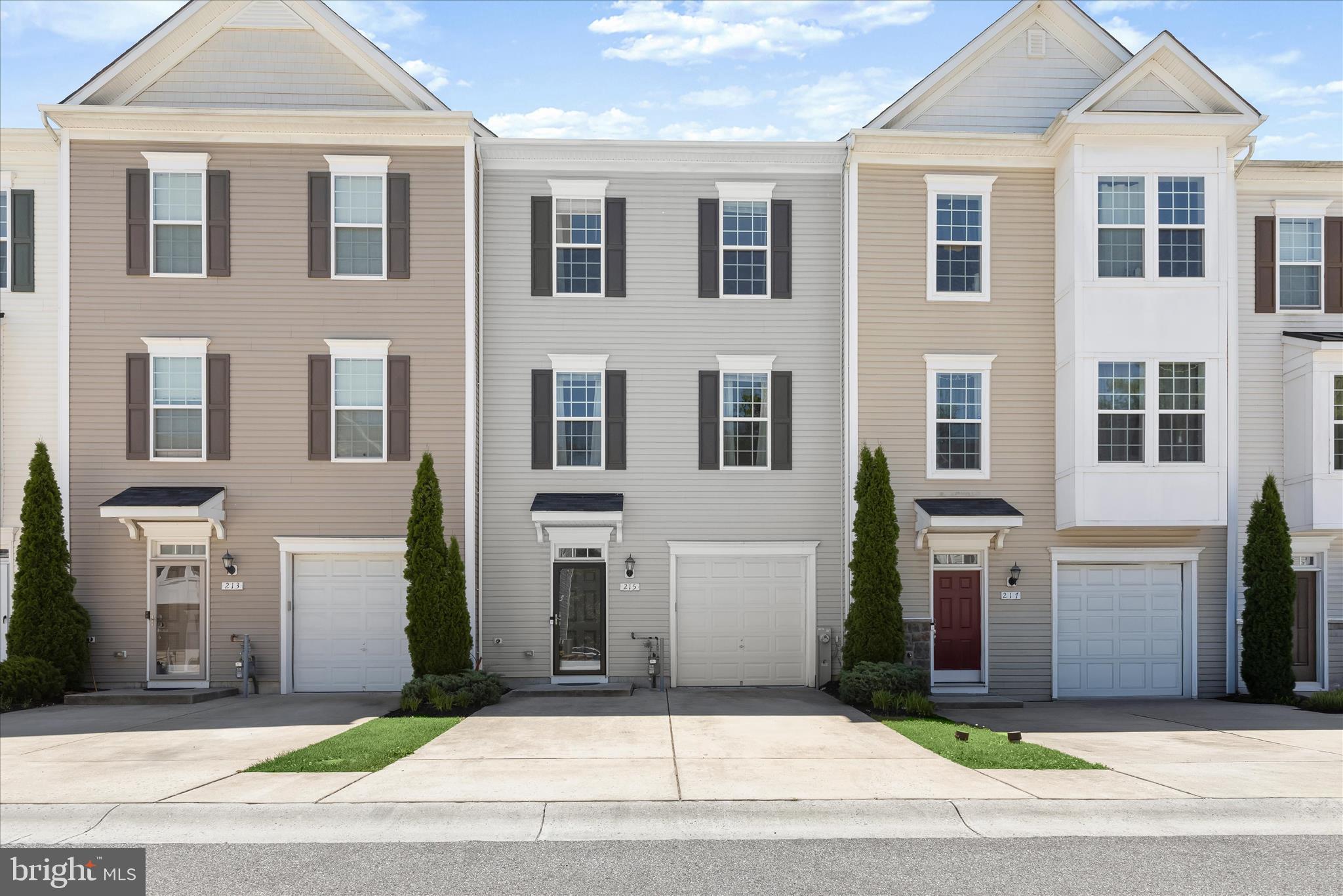 Meticulously maintained and beautifully designed, this three-level townhome in the desirable Pond View community offers versatile living spaces, modern finishes, and a private wooded backdrop. The entry level features a flexible suite with a bedroom and full bath, ideal for guests, multigenerational living, a home office, or potential home-sharing opportunities. The bright and airy main level showcases an open-concept floor plan perfect for everyday living and entertaining. The stylish kitchen is equipped with stainless steel appliances, a center island with breakfast bar seating, pendant and recessed lighting, and flows seamlessly into the spacious dining and living areas. Step outside to the rear deck and enjoy peaceful views of mature trees, creating a private outdoor retreat. Upstairs, the vaulted-ceiling primary suite offers a walk-in closet and a luxurious en suite bath with double vanities and a tiled walk-in shower. Two additional bedrooms, both with vaulted ceilings, share a full hall bath featuring ceramic tile flooring and a tiled shower. With three bedrooms, three-and-a-half baths, and a flexible lower-level space that could serve as a fourth bedroom, this home provides exceptional versatility. Complete with a one-car garage and thoughtful finishes throughout, this move-in ready home combines comfort, style, and convenience. Ideally located in the Pond View community, it offers easy access to shopping, dining, everyday conveniences, and major commuter routes, making it a fantastic place to call home.
