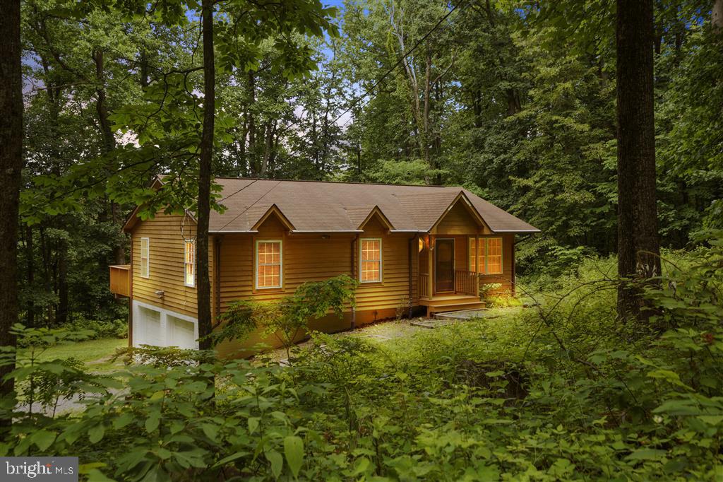 Fully furnished with hot tub, this stunning 1.33-acre corner lot home has been fully renovated in 2023. Originally built in 2003, upgrades include a brand-new HVAC system, full house water filtration, hot tub with warranty, new kitchen appliances, and overhauled septic. This smart home features a Nest system with thermostat, front door deadbolt, and driveway camera with floodlight for convenience. Enjoy refinished hardwood floors upstairs and new luxury vinyl flooring downstairs, plus a gas fireplace. Outdoor amenities include a detached storage shed, kids swing set, and a spacious deck with seasonal views (or trim the trees for a year-round vista). The property also offers community lake access.