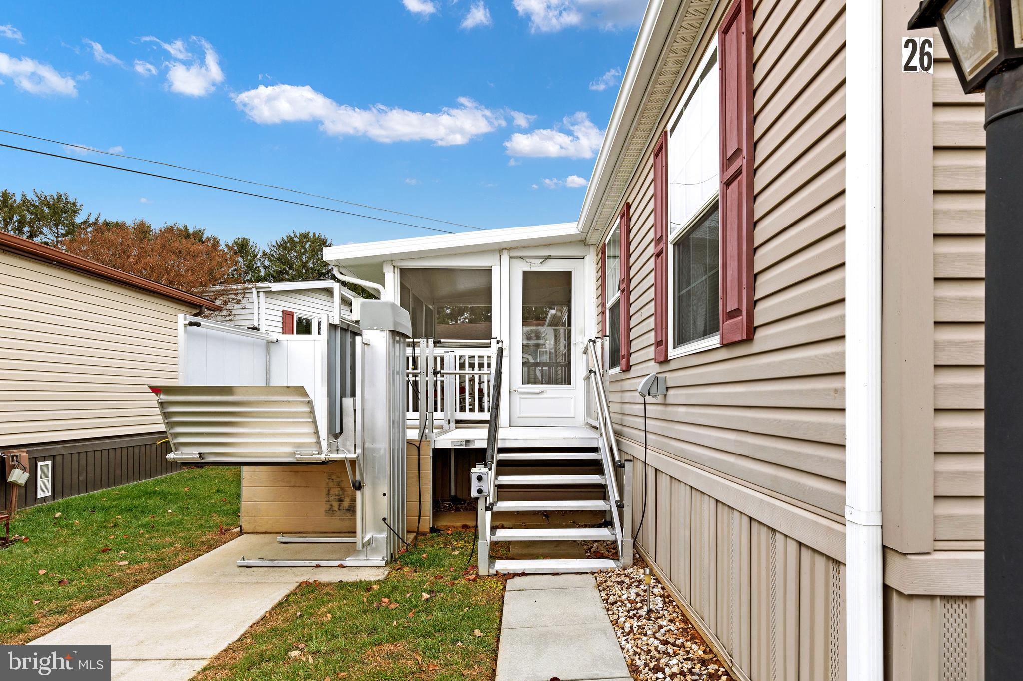 Situated in a well maintained and highly sought after 55+ community this 3 bedroom, 2 full bath Eagle River model offers an affordable and well appointed escape into the farmland of Lancaster County. The ADA lift makes stairs a non issue with excellent accessibility. Relax on the screened in porch or come on inside and enjoy this open floor plan with cook’s kitchen with gas stove, island living room and dining area! The kitchen hosts a spacious island, wood cabinetry, walk-in pantry with laundry. To the left of the great room is the primary bedroom with en suite bath including garden tub and shower. To the right are two additional spacious bedrooms and full bath. There is also an office or craft nook for some extra flex space. This is a very well cared for home in the desirable Triple J MHP.