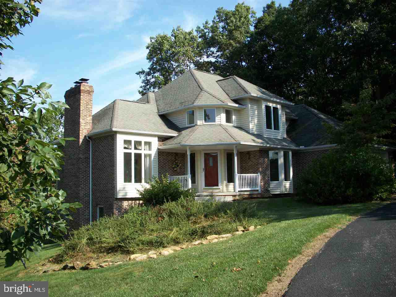 Custom built in a small community.  Features include a 1st fl master with whirlpool tub, shower and walk-in closet.  Living rm  has tall ceiling and windows.  Formal dining rm, open eat-in kitchen with access to lg deck and a 1st fl laundry.  Second floor has 3 large brs and bath.  Lower level has a full bath, family rm with full wall brick fireplace and 8' slider to covered patio plus a 24x17 finished rm with gas fp.  Possible 5th BR or in-law.