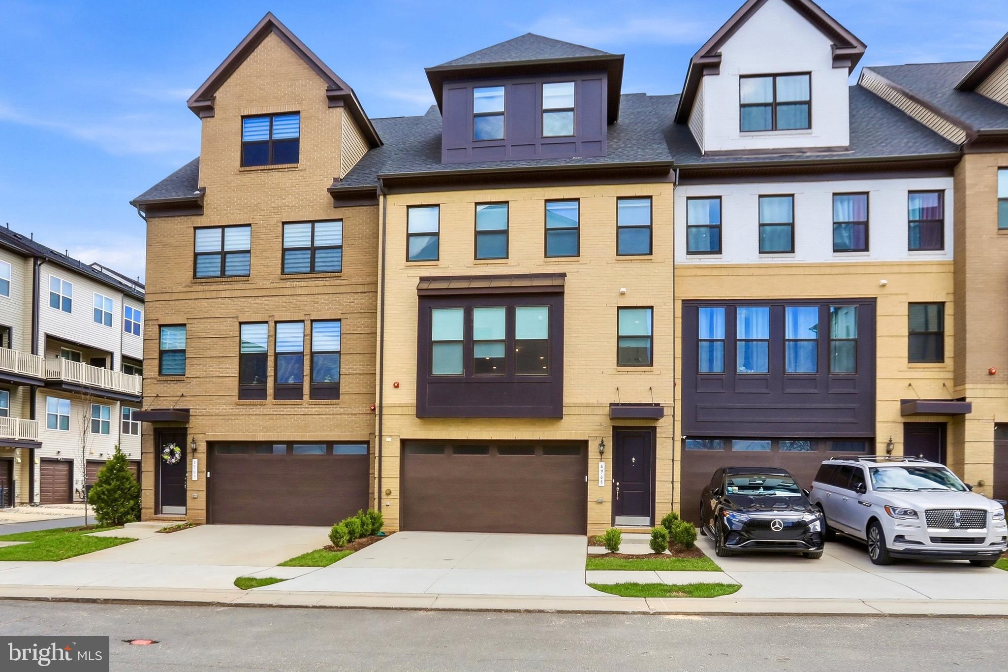Welcome to 4965 Longmire Way, an exceptional four-level townhome in the highly sought-after Boulevards at Westfields, where modern luxury meets effortless living. Built in 2023 by K. Hovnanian, this stunning Bennington II model offers over 3,100 square feet of thoughtfully designed space, featuring 5 bedrooms, 4 full baths, 2 half baths, and a 2-car garage.

From the moment you enter, you’re greeted by a bright, open-concept main level designed for both everyday living and elevated entertaining. The expansive great room flows seamlessly into the dining area and chef’s kitchen, creating a warm yet sophisticated gathering space. The kitchen is beautifully appointed with Absolute Black granite countertops with a leathered finish, premium cabinetry, and modern finishes. A sun-filled Florida room and multiple private balconies provide the perfect places to relax, unwind, or entertain.

Luxury vinyl plank flooring extends throughout the main and upper levels, complemented by custom automatic roller blinds that add both style and convenience. Every detail has been thoughtfully curated to deliver a clean, modern aesthetic.

The upper levels offer a spacious and flexible layout, including a serene primary suite and generously sized secondary bedrooms. The top-level loft provides a versatile retreat—ideal for a home office, media room, or private lounge—while offering access to additional outdoor living space.

The fully finished lower level enhances the home’s livability with abundant natural light, daylight windows, and multiple access points including garage entry, a private exterior entrance, and walkout access—perfect for guests, recreation, or multi-generational living.

Ideally located in Chantilly, this home is just moments from Eleanor C. Lawrence Park, where scenic trails, sports fields, and green space await. Enjoy convenient access to premier shopping, dining, and entertainment, along with easy commuting via Route 28, Route 50, I-66, and Dulles International Airport.

Offering an exceptional blend of space, style, and location, this nearly new home delivers the ultimate in luxury, comfort, and convenience.