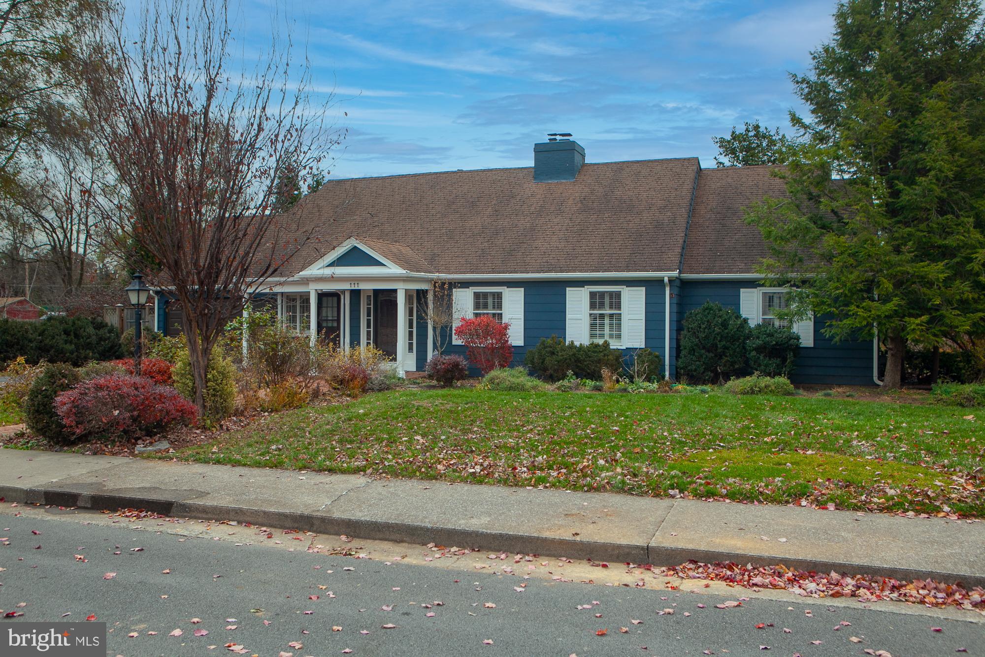 Substantial Price Drop  Motivated Seller  (Your Lucky Day) MUCH MUCH More than your average ranch house! (Contemporary) . Yes, a home with a  lake view  in-town.  1 acre property overlooks Lake Thomas.  Charming, elegant, spacious home on a quiet, non-through street, just minutes away from Memorial Park, Downtown Martinsburg and fine dining.  Combines possible one-floor living along with gracious capacity for a family. Second floor bedrooms, library, office. 
A delightful combination of city and country in this expanded mid-century home, 111 North Rosemont was built in 1968. Over time, the house was substantially expanded most notably with the addition of two large wings each with Palladian windows and soaring wood ceilings.  
All utility bills are available.  
The covered front porch welcomes you to the generously sized living room with south and west facing windows and an  elegant staircase to the second floor.  A gas fireplace with built-in bookshelves on one side, will warm your winter evenings.
The dining room has French doors looking to the fenced in patio.  Its east facing windows start your day with the morning sun. 
The bright, sunny kitchen with breakfast nook was totally remodeled in 2015 with solid wood cabinetry , high level granite counters, and an oversized island; renovated with attention to quality and detail. The warmth of the solid wood cabinets in a heather tone combines with the tones of the sweeping Pregrine granite counter tops. Focal points include the island and bank of cabinets offering a handy in-kitchen pantry.  Stainless steel appliances new in 2015, and a designer copper sink adds a French country touch.
From the kitchen, you are welcomed to an expansive den with a dramatic rose brick gas fireplace that extends upward to the vaulted ceiling. It is flanked by built- bookshelves on both sides.  A new ( 2023 ) bay window faces north, Palladian windows face East, and a set of French doors on the south opens to the enclosed patio and garden beds. 
The light-filled ground floor laundry room includes functional counter space and wood cabinets.
Other features: All second floor rooms are full height; a triple zone heating/cooling system updated in 2016 and 2019; ample closets;  and plantation shutters are installed throughout the house, with shades for the Palladian   windows.
The generously sized carriage shed boasts an automatic garage door, half  bathroom
 and large built-in work bench. The second floor, accessible via pull-down stairs, offers additional storage space.  Solar panels installed in 2020 contribute to energy savings every year. 
A longtime previous owner was an avid gardener. She laid out the rock garden design with its charming brick pathway and overall harmony  with the natural limestone outcroppings that add so much character to the backyard.  The park like  landscaped yard includes established perennials  beds surrounding the house with a pollinator pocket garden in the patio.  Peonies herald the spring as do numerous blooming shrubs throughout the summer.  But there's plenty of room for you to add you own touches.  Further along toward the lake are a  graceful willow tree and a charming cherry tree, both offering changing color throughout the year to the view from the kitchen window.  A majestic black walnut tree stands sentinel as you enter the lower yard and approach the west bank of Lake Thomas, a serene quarry lake in the middle of Martinsburg.
Convenient location.  Just blocks to down town Martinsburg, fine restaurants, Marc Commuter train to DC, EZ access to I-81.  Wonderful walkable neighborhood.