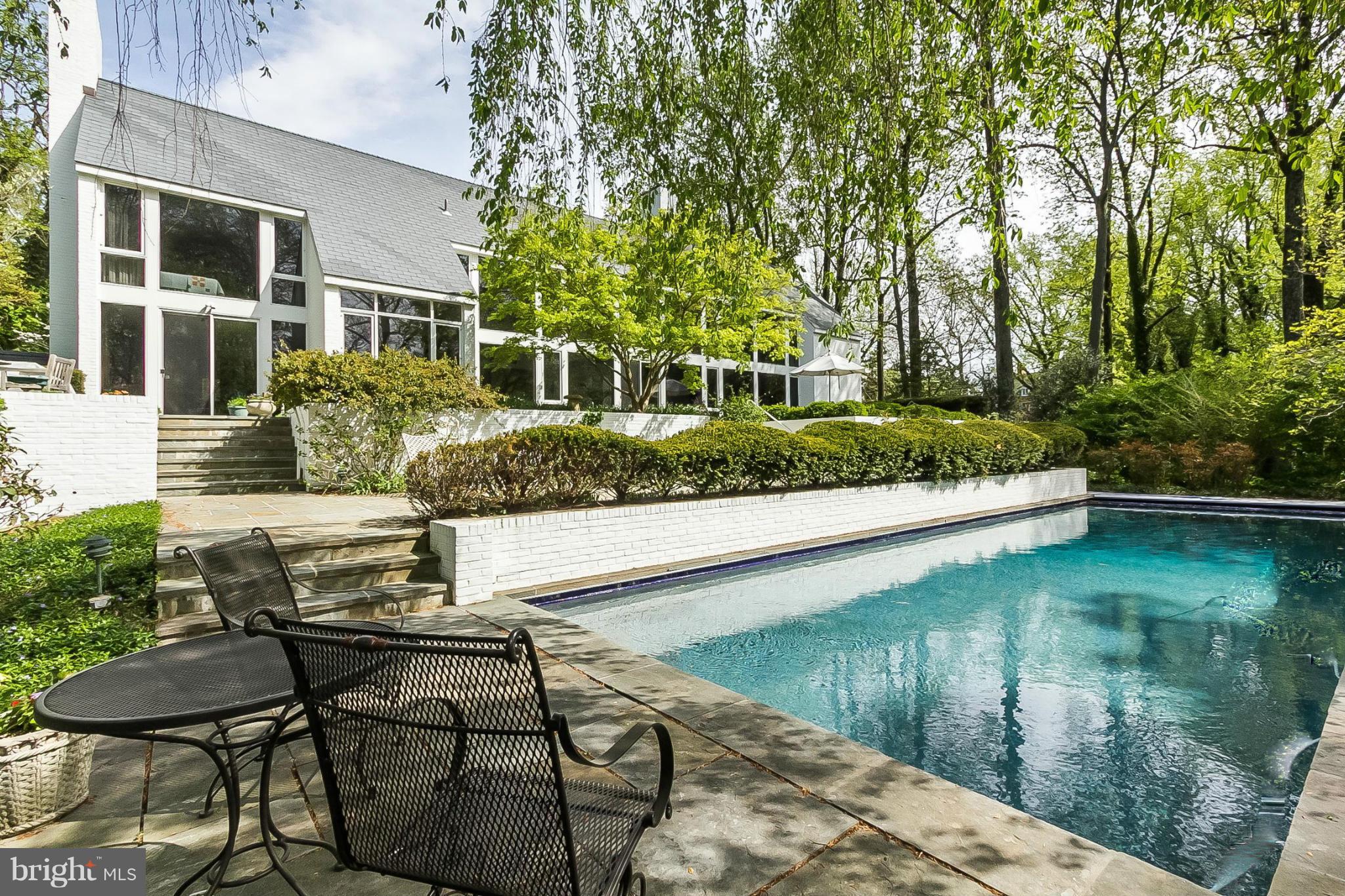 Uniquely private & close to everything, this Charles Richter designed 5000+sq ft gem tucked away on 9+ acres of woodlands gardens has to be seen to be appreciated. The custom home features a gourmet kitchen w/ attached FR, 4 FP, home office w/ sep. entrance, custom wine room, prof. landscaped grounds by Kurt Bluemel, multiple blue stone patios, in-gr swimming pool, walking paths and so much more.