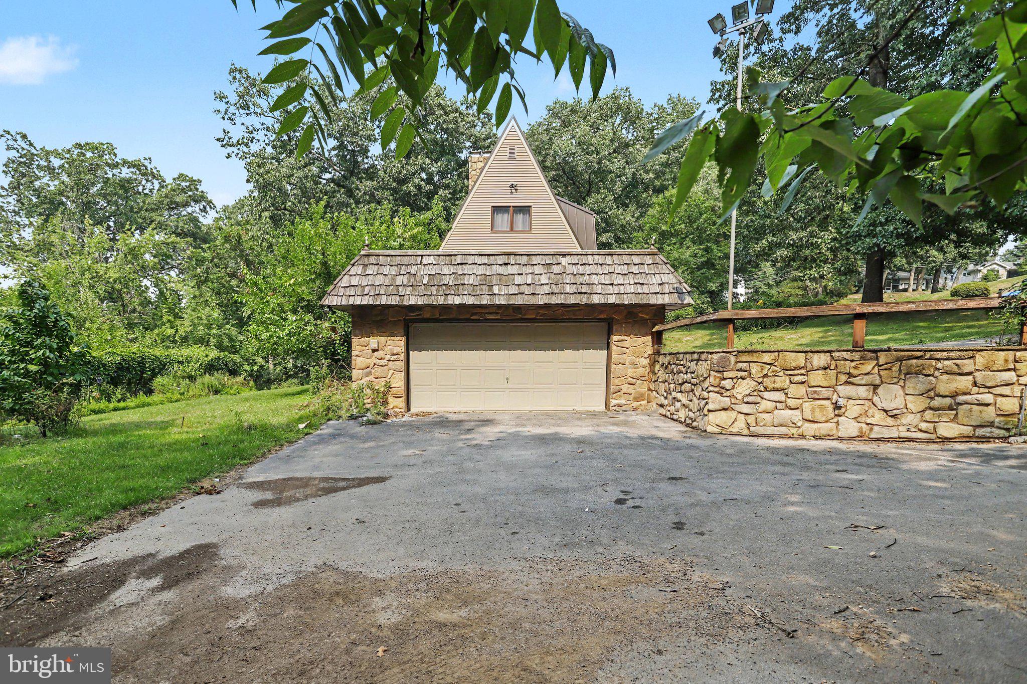 Rare opportunity to own a multi-acre property just off major Route 322 with possible subdivision from local surveyor on file! The acreage and prime location make this a truly unique offering with incredible potential. Spacious home featuring a main-level bedroom and full bath, 3 fireplaces, finished basement with bar, oversized garage, and plenty of room to grow. Major updates include siding (2018), water heater (2019), metal roof with LeafGuard gutters (2020), and a brand-new TRANE HVAC system (2025). Home is in need of  renovations and is being sold as-is. There is a leak from the main floor into the basement and a leak in the garage ceiling. Ideal for an investor, contractor, or buyer with renovation experience looking to add value or own a home with land in the middle of Harrisburg. Bring your vision and restore this rare property to its full potential!