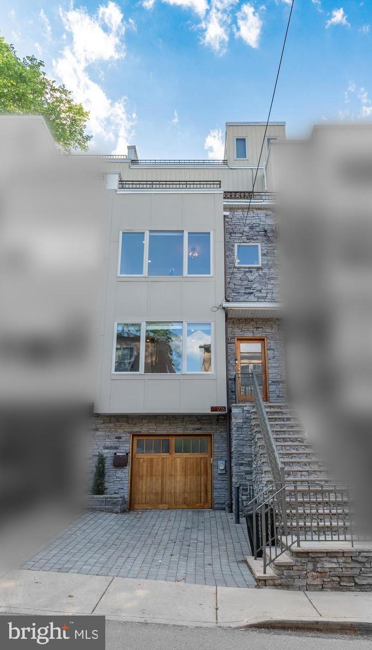 Experience the best of Manayunk living in this extraordinary four-story townhome, where luxury, convenience, and outdoor living come together in one of Philadelphia's most sought-after neighborhoods. Just moments from Main Street's vibrant dining, shopping, nightlife, and trail system, this exceptional residence offers the perfect balance of urban energy and private retreat.

Exceptionally spacious and thoughtfully designed, this stunning home offers room to live, work, entertain, and unwind with ease. An in-home elevator provides effortless access to every level, while rich hardwood floors, soaring 9-foot ceilings, and custom designer finishes create an atmosphere of sophistication throughout.

At the heart of the home, the gourmet kitchen is designed for both everyday living and entertaining, featuring leathered granite countertops, a Sub-Zero refrigerator, gas cooking, and an oversized center island. From morning coffee to evening gatherings, the home's three distinct outdoor spaces extend your living area beyond the walls. Enjoy intimate dinners on the private patio, relax with fresh air and sunshine from additional outdoor living areas, or host unforgettable gatherings on the expansive rooftop deck with sweeping views that showcase the very best of city living.

The second floor offers two spacious en-suite bedrooms, providing comfort and privacy for family or guests. Occupying its own level, the primary suite serves as a luxurious sanctuary with a generous walk-in closet, custom built-in cabinetry, and a spa-inspired bath featuring a rain shower designed for ultimate relaxation.

The finished lower level adds exceptional flexibility, offering the ideal space for a media room, fitness studio, home office, or guest retreat, with direct access to the private garage.

Combining luxury finishes, exceptional indoor-outdoor living, and an unbeatable Manayunk location, this is more than a home. It's a lifestyle defined by comfort, convenience, and the ability to enjoy everything the neighborhood has to offer right outside your door.