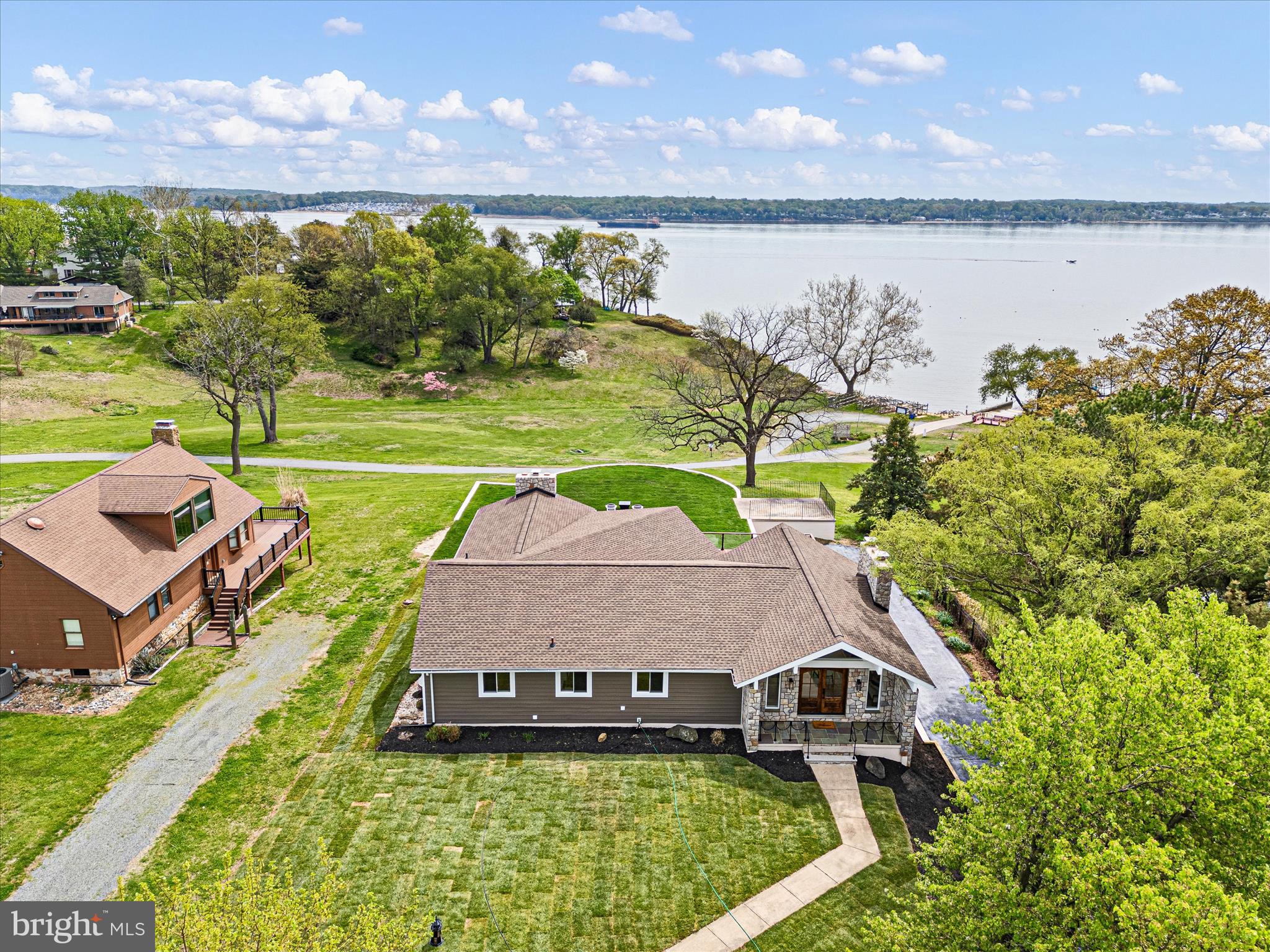 Wake up to shimmering water in this Coastal Contemporary perfectly positioned to capture panoramic water views.  This property, just remodeled, offers a seamless blend of comfort, elegance and natural beauty.  Enter through large wooden double doors to discover an open-concept layout filled with natural light, where expansive windows frame the water views from nearly every room.  The spacious Great Room, with dramatic stone fireplace and cathedral ceiling, flows effortlessly into a bright, modern kitchen featuring high-end finishes, like quartz countertops, glass-tiled backsplash, ample cabinetry, stainless appliances, and a large island which will be ideal for entertaining.  Solid wood-paneled doors and plank flooring throughout.  Easily located off the kitchen, is a large pantry/storage area and laundry/mudroom with washer/dryer hook up.  A one-of-a-kind floor to ceiling glass-paneled cabinet in the dining/gathering space is a show-stopper!  Ample windows provide a nearly unobstructed view of the water.  The Primary Suite is a private retreat, complete with serene water views, a generous walk-in closet, stone fireplace, and a spa-inspired ensuite bath.  The ensuite bath features tile flooring, quartz countertops , tiled shower with rain shower head and heated flooring.  Two additional bedrooms and a new center hall bath with ultra modern finishes provide flexibility for guests or family.  Outdoors, enjoy your own slice of paradise with a deck/patio designed for relaxing or hosting gatherings, all while enjoying stunning water views.  Whether it's morning coffee or evening get togethers under the stars, this home delivers a lifestyle that feels like a get away everyday!  A Grand, winding staircase ushers you to an expansive Recreation Room.  Luxury features include a stone fireplace, generous recessed lighting, and a glass doored Wine Closet.  Additional living spaces on this level add to the elegance of this home.  A 4th bedroom with and ensuite bath will be perfect for visitors.  A large den/office/craft room has lots of natural light streaming in to allow you to work or relax in comfort.  Revive and rejuvenate in another room which could be a Yoga Studio or Home Gym, with large transom style windows.  Another full bath completes this level.  Pristine 2+ car garage has ample space for a workbench area.  Located in the desirable, private, water-oriented community of Chesapeake Isle with a community boat ramp, harbor area, and dinghy/kayak storage area, this is a water-enthusiasts dream!   You can also entertain or enjoy the plethora of community activities from the pavilion area with a beach, volleyball and pickle ball court.  This water view gem is located next to Elk Neck State Park, Turkey Point Lighthouse, and minutes away from the quaint town of North East with access to several local amenities.   Easily accessible to I-95.  Experience the beauty, tranquility, and unmatched charm of bay living . . . this is more than a home, it's a lifestyle!