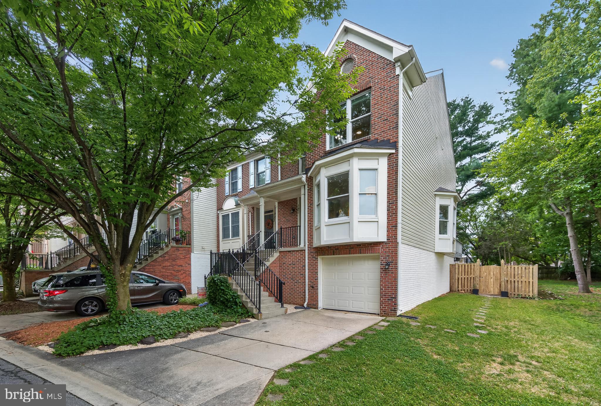**RARE FOUR-LEVEL END UNIT WITH AN AMAZING LOT ADJACET TO PARK LIKE COMMON AREA OFFERING ONE OF THE BEST LOTS IN THE NEIGHBORHOOD ** Welcome home to this beautifully maintained 3 BR/3.5 BA end-unit townhome with a one-car garage, offering an abundance of natural light and comfortable living spaces throughout. The bright and inviting living and dining room combination is enhanced by elegant crown molding and two charming bay windows that fill the home with sunshine. The spacious kitchen features ample cabinetry, a table-space dining area, and a sunny breakfast nook, perfect for enjoying your morning coffee. Sliding glass doors lead to a large deck overlooking the fully fenced backyard, creating the ideal setting for outdoor dining, entertaining, or simply relaxing. Upstairs, the expansive primary suite is a true retreat, complete with a luxurious ensuite bath and an impressive loft that makes a perfect home office, reading nook, fitness space, or private sitting area. Two additional bedrooms and a full hall bath complete the upper level. The finished lower level offers a spacious recreation room, a full bathroom, and a dedicated laundry room, with direct access to the fenced backyard for seamless indoor-outdoor living. Combining thoughtful design, flexible living spaces, and a wonderful layout, this move-in-ready home is the perfect place to create lasting memories. Perfectly situated for commuters, this home offers easy access to I-270, I-370, and the ICC (MD-200), while being just minutes from shopping, dining, and everyday conveniences. Don't miss the opportunity to make it yours!  UPDATES: New siding, repaired/replaced all rotten trim, new carpet in basement and 3 staircases, freshly painted, painted deck, renovated primary bedroom/bathroom, and new light fixtures throughout home.