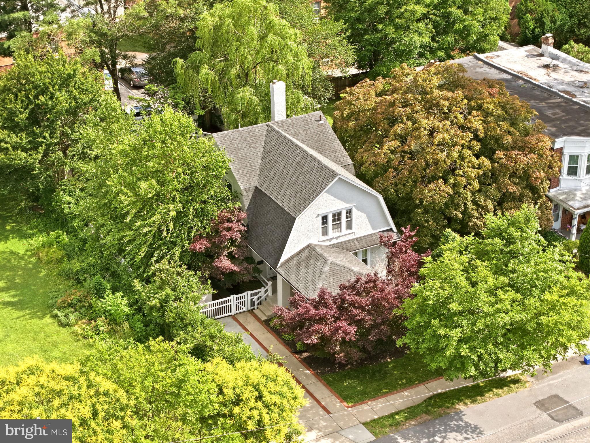 If you have been waiting for a Roxborough home that blends classic charm with modern convenience, this gorgeous Dutch Colonial is the one. A welcoming oversized covered front porch sets the tone before you step inside to bright, spacious living and dining rooms featuring gleaming hardwood floors and wonderful natural light. The updated kitchen is designed for both everyday living and entertaining, offering an open layout with a breakfast bar, island, granite countertops, and stainless-steel appliances. A full bathroom with a jacuzzi tub completes the main level.
Upstairs, you will find four bedrooms and an updated hall bathroom with a stall shower. For added convenience, laundry is currently located in one of the bedrooms, though it could easily be relocated back to the basement if preferred. The fully waterproofed basement offers excellent storage and excellent potential to be finished for additional living space.
Step outside from the kitchen to your own backyard retreat. The large fenced-in yard features a multi-level Trex deck, gas fire pit, lower-level stone patio, swing set, and two sheds — ideal for relaxing, entertaining, and enjoying the outdoors.
Perfectly located in the heart of Roxborough, this home offers the best of both worlds — suburban neighborhood vibes with the walkability of city life. Enjoy being walkable to local stores, shopping, and dining, while still just minutes from public transportation, major highways, and Main Street Manayunk. This Roxborough gem offers the space, character, convenience, and lifestyle you have been looking for.
Notable Improvements & Updates
High-velocity central air was also installed in October 2019.
Prior to move-in in November 2019, all knob-and-tube wiring was removed and replaced with Romex wiring. Multiple additional outlets were added to the bedrooms, and wiring was added for the family room lamp. The upstairs carpet was also removed, and the hardwood floors on both levels were refinished. 
In February 2020, a glass shower door was added, and the driveway was extended to accommodate two vehicles, offering expanded off-street parking.
A new Bradford White water heater was installed in July 2020.
In July 2021, the stairwell was carpeted, and under-cabinet lighting was added in the kitchen.
In December 2021, the basement was waterproofed with the addition of a French drain and sump pump. As part of this project, the side walkway was also redone to improve drainage and slope water away from the foundation.
Additional improvements include the swing set installed in April 2022, a second shed added on the side of the house in July 2022, a new vanity and light fixture in the upstairs bathroom in March 2025, and a brand-new heater/boiler installed in December 2025.