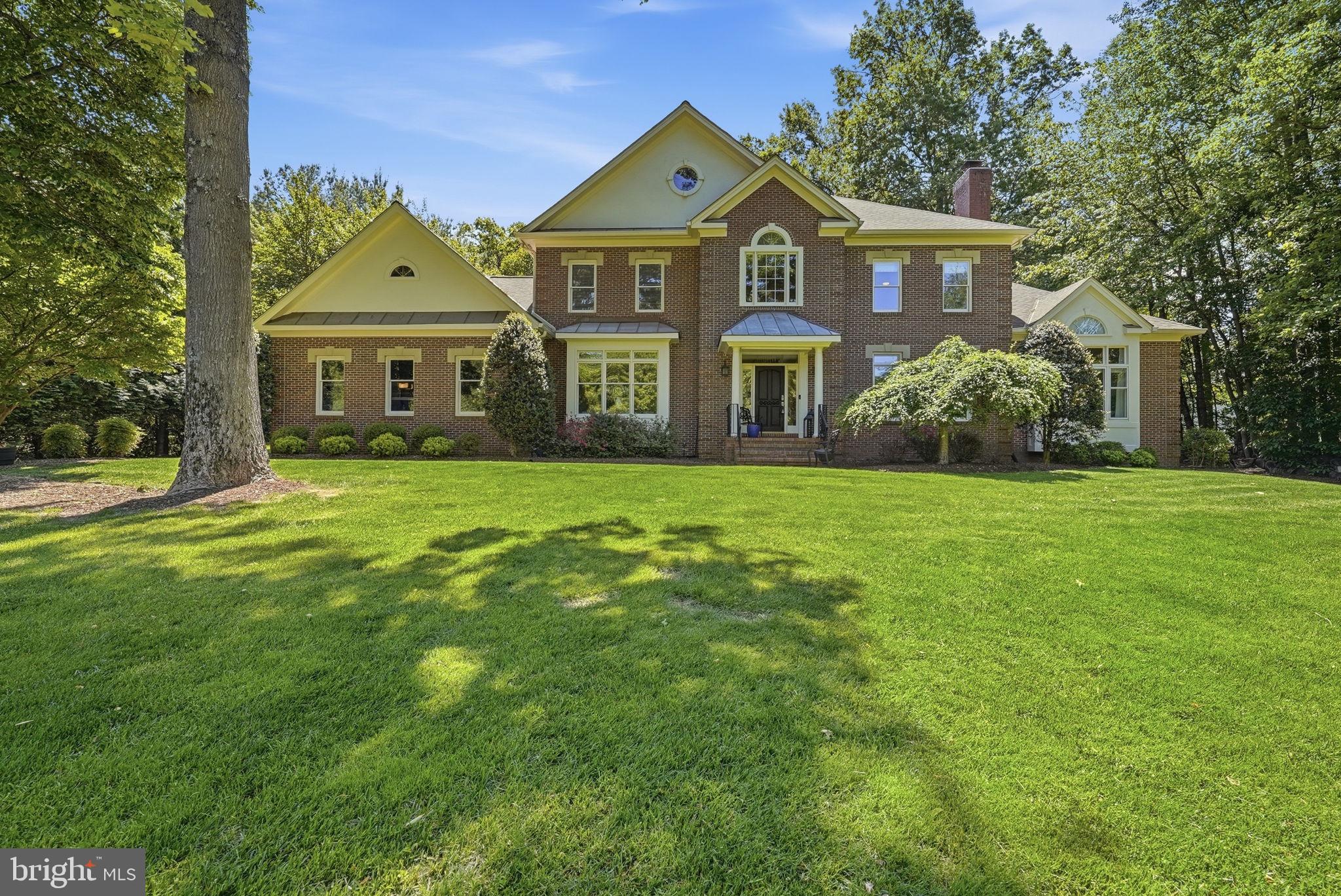 Don’t miss the opportunity to own this exceptional brick Colonial nestled on a beautifully elevated 1.07-acre homesite in prestigious Tilton Valley Estates.

Highlights include: Main-level primary suite • Additional Second-level primary/extended family suite • kitchen with professional 36" gas range and griddle • Double wall ovens with built-in microwave • Sweeping circular staircase foyer • Bathroom renovations throughout • two-story great room • Three fireplaces • Finished walk-up lower level with wet bar • Expansive deck overlooking trees • Attached three-car garage • Under ground irrigation system 

Surrounded by mature trees and lush landscaping, this elegant residence offers a serene sense of privacy while remaining just minutes from Fair Oaks Hospital and a wide array of shopping, dining, and everyday conveniences.

A dramatic two-story foyer with a sweeping circular staircase welcomes you into an interior designed for both refined living and comfortable everyday life. The main level features formal living and dining rooms highlighted by a gas fireplace, while the impressive two-story great room with fireplace creates a stunning centerpiece for gatherings and entertaining.

At the heart of the home is the gourmet chef’s kitchen, thoughtfully designed with a professional 36-inch gas range with griddle and hood vent, double wall ovens with built-in microwave, warming drawer and generous prep space ideal for hosting family and friends.

The luxurious main-level primary suite offers a peaceful private retreat with vaulted ceilings, a spacious walk-in closet and a beautifully renovated spa-inspired bath featuring a soaking tub and oversized walk-in shower.

A private office with custom built-in shelving and exterior access to the updated deck provides the perfect work-from-home setting.

Upstairs, a second primary suite with a renovated bathroom offers excellent flexibility for guests or extended family. Two additional spacious bedrooms share a beautifully updated buddy bath.

The fully finished walk-out lower level expands the home’s lifestyle appeal with a third fireplace, wet bar, two sitting areas, 5th bedroom, full bath, exercise room, and direct access to the backyard—ideal for entertaining or multi-generational living.

Outdoor living is equally impressive with an expansive private deck overlooking a tranquil wooded backdrop, creating the perfect setting for al fresco dining, gatherings, or simply enjoying the peaceful surroundings.

Additional highlights include an attached oversized three-car garage and generous driveway parking. The home is ideally located with convenient access to major commuter routes, an airport less than 10 miles away, and a Metro station within three miles.  Coveted Fairfax County Schools include: Navy Elementary, Franklin Middle School & Oakton HIgh School

Offering a rare blend of luxury, space, privacy, and convenience, this remarkable property presents an exceptional opportunity to enjoy refined living in one of the area's most desirable communities.
