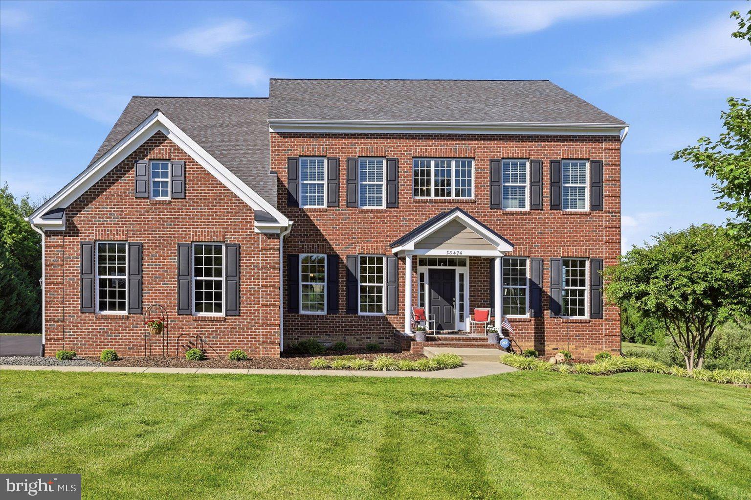 Welcome to this meticulously maintained single-family home nestled on 3 beautiful acres in the heart of Hamilton, where privacy, elegance, and convenience come together to create the perfect place to call home. From the moment you step into the impressive two-story foyer, you'll appreciate the thoughtful design and timeless appeal of this exceptional property. The formal living room sits to the right of the entry, while the formal dining room to the left provides the perfect setting for holiday gatherings and special occasions. A spacious main-level office with a charming bay window offers an ideal work-from-home space, while a convenient powder room completes the main level. At the heart of the home is the beautifully appointed kitchen featuring a large center island, granite countertops, cooktop, wall oven, stainless steel appliances, and a casual dining area perfect for everyday meals. Plantation shutters, added in 2018, enhance the home's warmth and character. Just beyond the kitchen, step out to the expansive Trex deck and screened porch, where you can enjoy peaceful mornings, outdoor dining, and breathtaking views of your private surroundings. The adjoining family room is truly spectacular, showcasing a floor-to-ceiling stone gas fireplace, coffered ceilings, and an abundance of windows that fill the space with natural light. A practical mudroom adds everyday convenience. Upstairs, the luxurious owner's suite serves as a private retreat with a spacious sitting area, large walk-in closet, and a beautifully updated owner's bath. Two secondary bedrooms share a Jack-and-Jill bath, while an additional bedroom enjoys its own private full bath, providing comfort and privacy. The home features 9-foot ceilings on both the upper and lower levels, enhancing the sense of openness throughout. The walkout lower level offers exceptional flexibility with a large recreation room, a spacious bedroom with a generous closet, a full bath, and an additional room that can easily serve as a second home office, fitness room, hobby space, or guest room. Two large unfinished storage areas provide ample room for seasonal items, tools, and future possibilities. Adding even more value, the home is equipped with a water filtration system for enhanced comfort and peace of mind. Surrounded by mature landscaping and open space, this property offers peace and  tranquility while remaining just minutes from shopping, dining, schools, and everyday conveniences. Opportunities like this are rare—an impeccably maintained home on 3 acres in one of Hamilton's most desirable locations. Come fall in love, imagine the memories waiting to be made, and make this exceptional property your forever home. Photos may be virtually staged