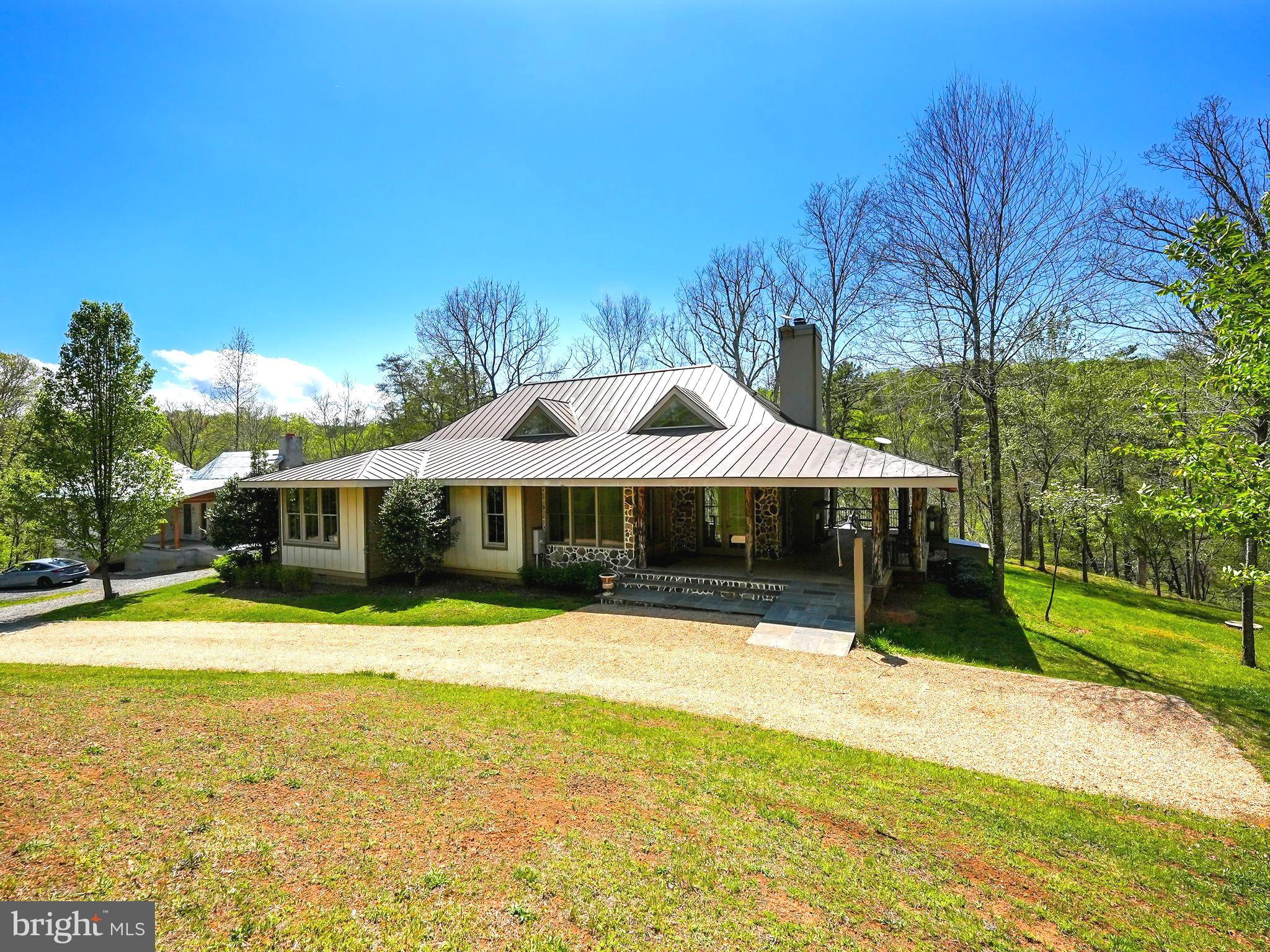 Your New River House Retreat Awaits- Welcome to Falling Pines

Nestled on the Rappahannock River amidst the tranquil valleys of the Shenandoah Mountain Range, just a 1 hour drive from DC, this extraordinary property offers a lifestyle of tranquility, surrounded by breathtaking natural beauty. Encompassing 20 rolling acres, this estate serves as both a perfect weekend retreat or a primary residence. A rare find, with nearly a 1/2 mile of Rappahannock River frontage, the property provides the opportunity to immerse oneself in the tranquility and adventure of Virginia's countryside.  Great Potential for a Vineyard or Airbnb

Main Residence Details:
Built in 2012, and crafted with meticulous attention to detail, this custom-designed home draws inspiration from the award-winning Tideland Haven plan, as featured in Southern Living. Indoor and outdoor spaces are connected by expansive windows and doors that flood the interiors with natural light. The heart of the home boasts an open floor plan with volume ceilings and hardwood floors. The spacious family room with a wood burning fireplace flows to the well appointed kitchen and dining area. A separate laundry room and pantry is located just off the kitchen. The office can be used as a overflow bedroom if needed. A bonus Loft area makes a fun play area for kids or a private reading nook. The private 3 bedroom area can be closed off from the main entertaining area. Each of the 3 bedrooms has its own en-suite bath adorned with high-end finishes. The primary suite with a cozy gas fireplace, offers a deluxe bathroom with a dramatic water room and a private porch with River views. Step outside to a covered wrap-around porch, complete with a wood-burning fireplace, sophisticated lighting, and ceiling fans, creating an inviting ambiance for both entertainment and relaxation.

Additional Structures:
Partially Completed Guest House:1,000 sq ft of sophisticated living space awaiting completion offers privacy and luxury for guests or extended family. : Custom finishes already purchased for completion convey with the property. Guest House conveys in As Is Condition
Cozy Studio: Featuring heated floors and a wood-burning fireplace, this charming retreat serves as a private studio or additional bedroom.
Three-Level Stone Tower: Crafted from native granite and quartz, this unique feature provides a creative space or a secluded escape to enjoy the property's natural beauty.
Woodworking Barn: Tailored for woodworking enthusiasts, equipped with a supply of wood milled from the property, ideal for crafting projects.

Outdoor and Recreational Features:
Private 20 Acres: A harmonious blend of fields and woods set against Virginia's picturesque rolling hills, offering serenity and natural splendor. Designated as agricultural, the property may offer tax advantages.
Rappahannock River Frontage: Enjoy nearly a 1/2 mile of access to one of Virginia's most scenic rivers, perfect for fishing, kayaking, or simply basking by the water's edge.
Natural Springs and Diverse Flora: Discover several natural springs and an array of tree and plant species, including a curated Orchard with over 30 of young plum, peach, pear, apple, and cherry trees, along with various berries.

Outdoor Adventures:
Explore on-property hiking trails, camping spots, and stargazing opportunities, creating an outdoor enthusiast's paradise.

Location and Local Attractions:
Situated near esteemed dining destinations like The Inn at Little Washington and the Shenandoah Park System, this estate offers both tranquility at home and nearby adventure.

More than just a residence, this property epitomizes a lifestyle of luxury, comfort, and natural splendor. A rare gem nestled in the Shenandoah foothills, it awaits those who cherish the finer things in life and the timeless allure of  Virginia's landscapes. Perfect for a Vineyard or Airbnb