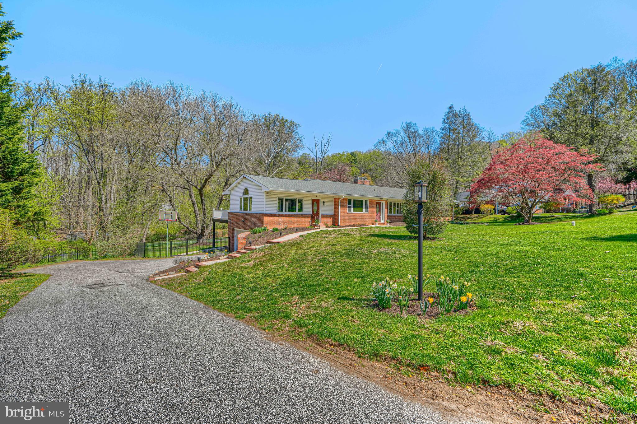 Welcome to 802 Stone Barn Road, a beautifully updated brick rancher set on over an acre in one of Towson’s most established and desirable neighborhoods. Combining classic mid-century character with extensive modern upgrades, this five-bedroom, three-and-a-half-bath home offers space, comfort, and true peace of mind.

Inside, more than 3,300 square feet of finished living space features hardwood floors, exposed beams, skylights, and two fireplaces, creating a warm and inviting atmosphere. From 2024–2026, the home underwent significant renovations, including fresh paint throughout, updated lighting, modernized outlets and switches, and full remodeling of all five bedrooms. Multiple bathrooms have also been renovated, including the half bath, main hall bath, basement full bath, and the primary shower, giving the home a clean, move-in-ready feel.

The fully finished walk-out basement has been completely remodeled and professionally waterproofed, providing flexible space for entertaining, recreation, or multi-generational living. A sump pump system ensures the lower level remains dry and protected year-round.

Major system upgrades further enhance long-term value and efficiency. The home was converted from oil heat to a 500-gallon underground propane system and now features a new furnace, hot water heater, and upgraded copper plumbing. These improvements offer modern reliability and reduced maintenance concerns for future owners.

Outside, the expansive lot offers both privacy and usability. Recent exterior improvements include a new aluminum fence, regrading of the front yard with French drainage, a newly constructed retaining wall, and structural reinforcement above the garage. A screened patio and rear deck provide inviting spaces to relax or entertain while overlooking the spacious backyard.

With its generous layout, over-acre setting, and extensive structural, mechanical, and cosmetic upgrades already completed, 802 Stone Barn Road presents a rare opportunity to own a thoughtfully improved home in a prime Towson location—without the cost or uncertainty of future major renovations.