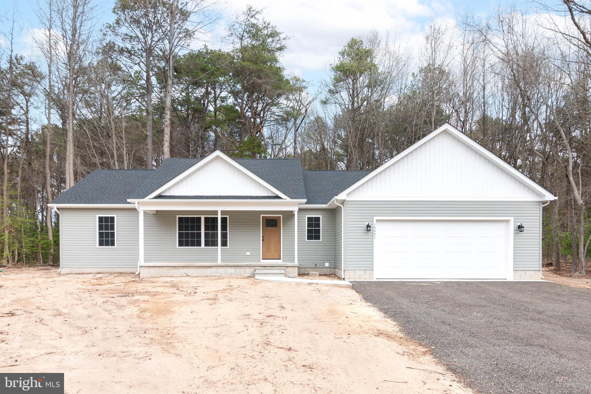 Beautiful new construction home featuring an open-concept design and vaulted ceilings in the main living area, creating a bright and spacious feel throughout the home. The kitchen offers white cabinetry, granite countertops, stainless steel appliances, and a large island that opens to the living and dining areas. Just off the main living space is a sunroom filled with natural light that leads to a concrete patio overlooking the backyard. The home includes 3 bedrooms and 2 full bathrooms, including a primary suite with tray ceilings, a private bathroom, and walk-in closet. Additional features include luxury vinyl plank flooring throughout the main living areas, carpet in the bedrooms, a separate laundry room, conditioned crawl space, and floored attic storage above the garage. Situated on a 0.76-acre lot, this home offers comfortable single-level living with thoughtful finishes and functional space both inside and out. Certificate of Occupancy has been obtained, allowing for a quick closing and the opportunity to be settled in before the end of April!