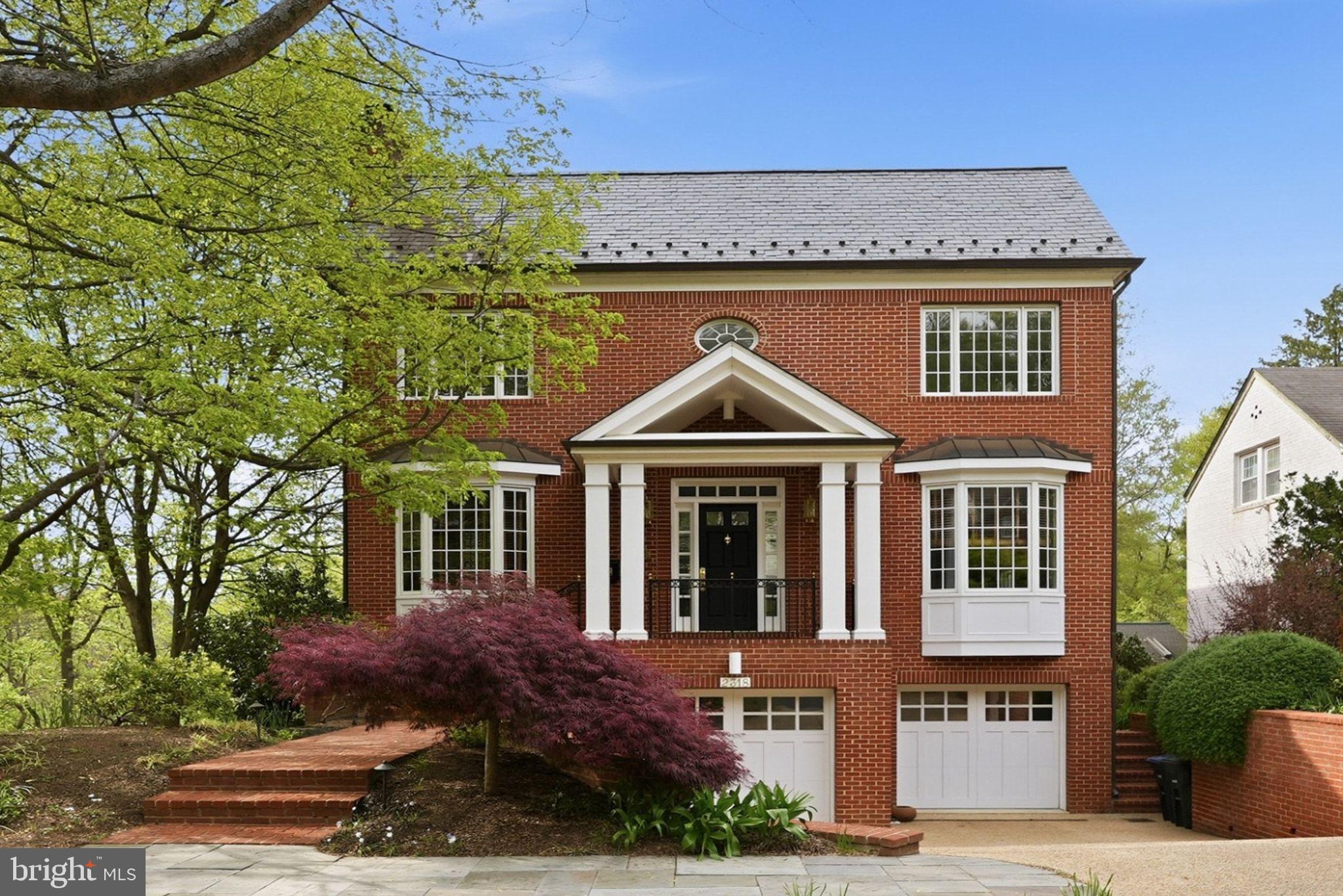 Perfectly positioned on a quiet street in the heart of the Palisades, this all-brick center hall colonial offers a rare combination of privacy, scale, and natural beauty. Designed by award-winning architect David C. Mitchell, the residence is thoughtfully sited alongside U.S. Park Service land, with views toward the Potomac River and the C&O Canal, and direct access to Battery Kemble Park and the Palisades Trolley Trail.

Offering nearly 4,500 square feet of finished living space, the home is defined by its impeccable construction quality and timeless finishes. Warm hardwood floors, custom millwork, high ceilings, and expansive windows fill the interiors with natural light while framing serene, wooded vistas throughout.

The main level is both elegant and functional, anchored by a gracious center hall. A cherry wood-paneled library, which can also be used as a den, features a wood-burning fireplace and creates a warm, inviting retreat, while the formal dining room is well-proportioned for both intimate gatherings and larger-scale entertaining. The rear of the home opens to a well-appointed kitchen featuring a Viking range, Sub-Zero refrigerator, generous island, abundant cabinetry, and a walk-in pantry, seamlessly connecting to the family room and overlooking the surrounding landscape. A full bath on this level adds flexibility for guests or everyday living.

The upper level features three spacious bedrooms, including a private primary suite with dual exposures and tranquil views. The suite offers two walk-in closets and a well-appointed bath, creating a comfortable and refined retreat. Two additional bedrooms, each with excellent light and ample closet space, are served by a large hall bath.

The lower level adds exceptional versatility, with a fourth bedroom and full bath, and a spacious recreation room distinguished by its ceiling height and natural light, with expansive windows that capture beautiful, unobstructed views. The space opens directly to a secluded patio, creating an easy connection to the outdoors. Additional storage and a dedicated laundry room are thoughtfully incorporated on this level.

An oversized, heated two-car garage with built-in shelving and workspace completes the offering.

Set within a uniquely private, park-like setting, this residence offers immediate access to trails and green space, and is within walking distance of the Palisades’ celebrated restaurants, while remaining moments from the conveniences of greater Northwest Washington.