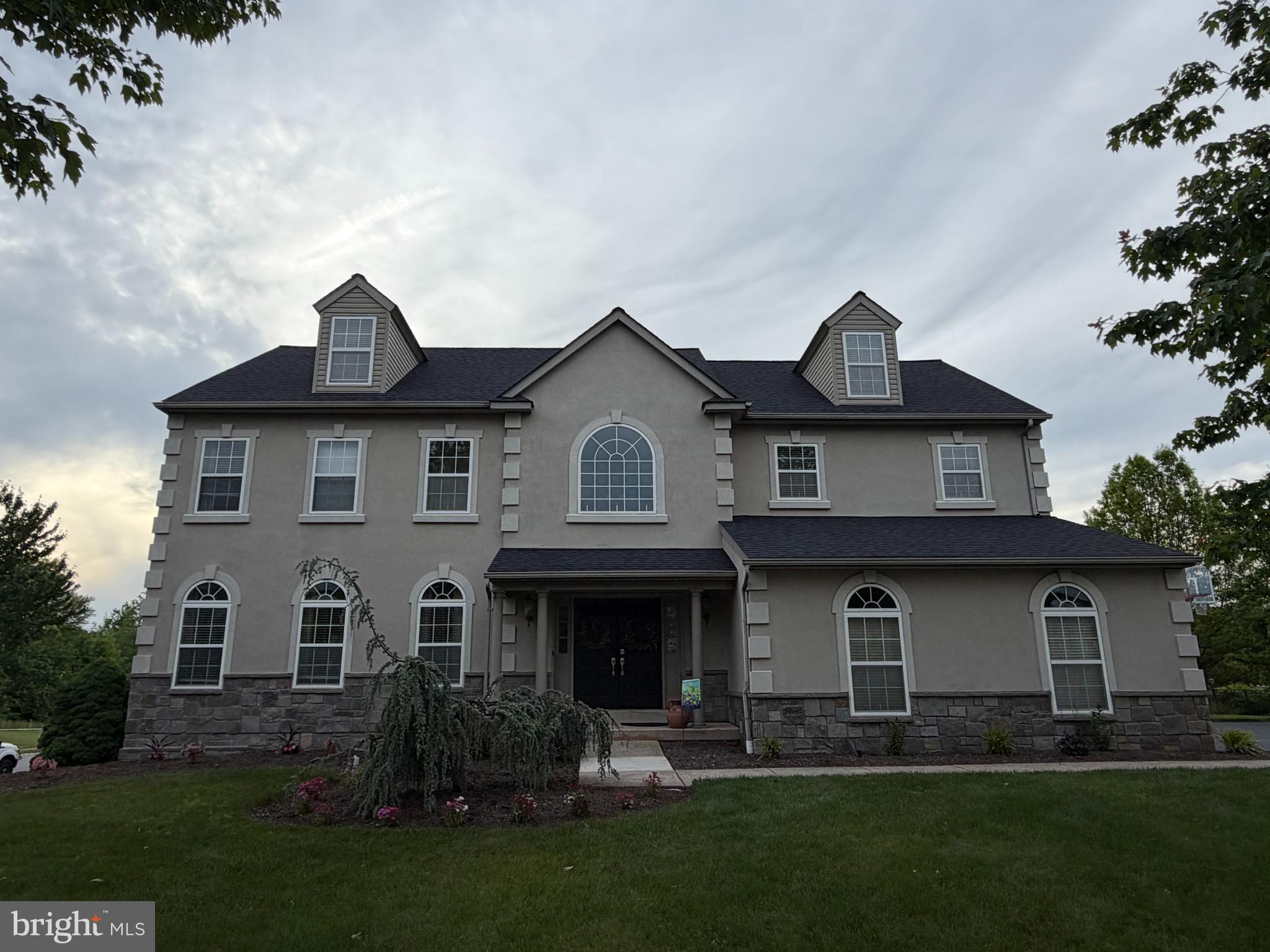 This exquisite residence nestled in prestigious Skippack community, offers a harmonious blend of luxury and comfort, perfect for those seeking an elevated Lifestyle.  This stylish 54 distinctive homesite neighborhood allows for a gentle stroll through Skippack known for its tremendous variety of the Arts, Culture and Entertainment.   Spanning an Impressive 5100 SF with an additional 450 SF Unfinished space.   Buyer to verify homes SF.  This 2 year warranted home is a sanctuary of elegance, set on a sprawling premium 3/4 acre lot providing versatility of outdoor enjoyment.   Current owners- one of which is a PA licensed Real Estate agent, having established a sporting lifestyle including winter classic Ice Hockey/skating and spring soccer field fest. New owners can create any other outdoor oasis with abundance of land to do so.  The  NiceRink system shall create unbelievable memories for adults and children alike.   As you approach the property, the charming and inviting front boasts arched windows inviting you in, hinting at the warmth and sophistication that awaits inside.  Imagine hosting intimate gatherings with space for all enjoyment.  A second lower level kitchen allows for secluded entertainment spilling into an outdoor oasis with a gorgeous earthtone Timbertech deck with tranquil mood lighting.   This 5 Br 2/2 bath residence boasts a 4th floor huge bedroom abutting both additional Living room space, home office and playroom.  The lower level bathroom system has capability for an additional shower to be created.  With a walkout lower level personal gym and creative studio in an unfinished area, the additional customizations are endless.  A cozy gas fireplace graces the primary living area along with a roughed in Lower level ventless fireplace.  The property's thoughtful design allows for exterior under deck storage, a generously sized rear shed and an abundance of parking due to its premium corner lot location.  Interior photos published 5/30.  
 The Skippack Community lifestyle is renowned for its exclusive lifestyle, offering a tranquil retreat with upscale shopping, fine dining, and recreational activities including Palmer park, Skippack pool club as well as nearby Horse riding clubs.  This residence is not just a home; it's a lifestyle choice that embodies luxury living at its finest.  Experience the perfect blend of comfort, elegance, and leisure in this remarkable property.  Whether your entertaining guests or enjoying the quiet moments at home, your life's promises will create a cherished retreat for years to come.