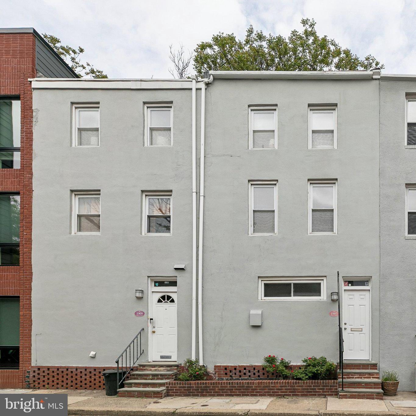 This rare Rittenhouse Square side-by-side duplex presents an exceptional investment opportunity or ideal owner-tenant setup. The main unit, 1907 is a 2-bedroom, 1.5 bath home featuring a private patio and a deck off the primary suite, while 1909 is a beautifully updated 1-bedroom, 1-bath apartment with its own private patio, perfect for rental income or multi-generational living.

1907: The kitchen features crisp white cabinetry and a peninsula with bar seating, and, a dedicated dining area that leads to a private outdoor patio, ideal for indoor-outdoor living. Upstairs, the living room is a bright and inviting retreat, anchored by oversized windows that flood the space with natural light and create an airy, open feel. Generous in scale, this level offers ample room for both lounging and entertaining. Up one more level, you’ll find two well- appointed bedrooms. The front bedroom enjoys southern exposure, filling the space with natural light, along with generous closet space. The main bedroom features vaulted ceilings, ample storage, and direct access to your private balcony. A full bathroom completes this level.The unfinished basement includes a laundry, a half bath and is ideal for storage.

1909: A beautifully updated 1-bedroom, 1-bath apartment with a bright, open layout and modern finishes throughout. The main living space is warm and inviting, featuring hardwood floors, large windows that bring in great natural light, and an open concept floor plan. The kitchen is thoughtfully designed with light wood cabinetry, granite countertops, a subway tile backsplash, and stainless steel appliances. The stacked washer and dryer are housed in a hallway closet, allowing for convenient access. A private brick patio is directly off of this space. The bedroom is generously sized with ample closet space and the full bathroom features clean tile work, a tub/shower combination, and a modern vanity. With its own private entrance, outdoor space, and updated interiors, this unit is ideal as a rental, guest suite, or owner-occupied space with income potential.

Enjoy city living at its best, just a short stroll to Rittenhouse Square Park, South Street, and neighborhood favorites like Pub & Kitchen, Southgate, Sabrina’s Café, and City Fitness. Commuters will love the convenient access to 30th Street Station for travel to New York or D.C., the University of Pennsylvania, and the direct line to the airport via Penn Medicine Station.