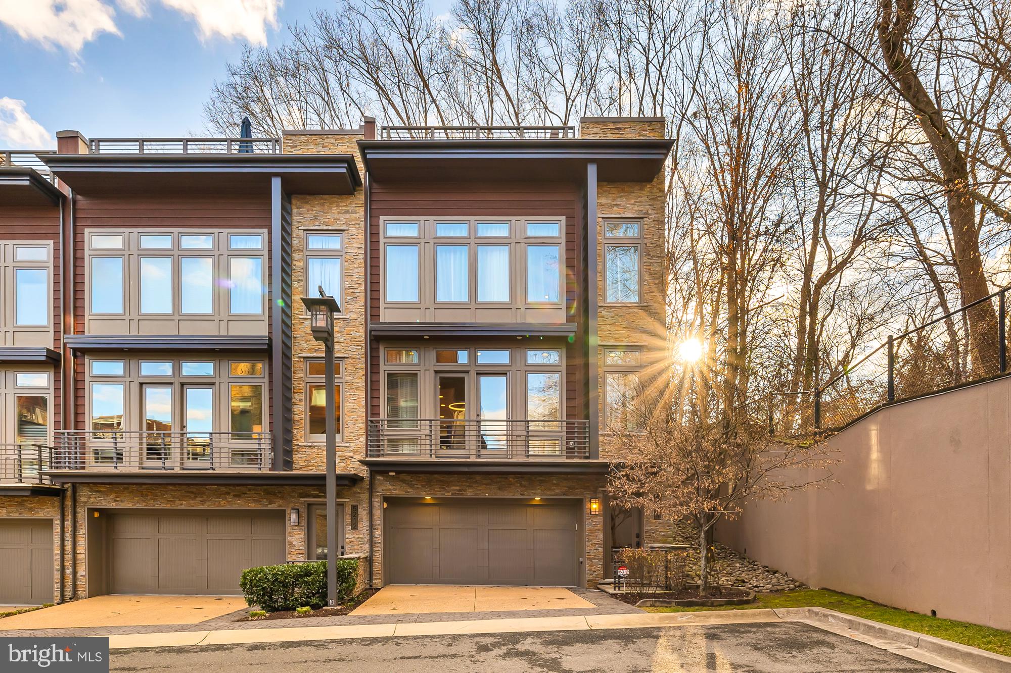 Seldom does a living opportunity like this come along. Welcome to your luxury dream home at Little Falls Place in Bethesda - a close-in 30 townhome development by acclaimed local developer EYA.  This home is located just minutes from the Washington DC line as well as easy and quick access to major transportation routes and bus lines. Yet it’s surrounded by lush, wooded acreage and immediately adjacent to the Capital Crescent Trail. This is a nature lover’s delight in a sumptuous space. Peace and quiet, convenience and luxury all in one. 

This coveted End Unit townhome is a rare offering at Little Falls Place - perfectly private with additional light from windows only an end unit can offer. A private elevator serving all 4 levels including the spacious rooftop terrace and three levels of living space, make for an inviting, comfortable and convenient lifestyle along with a two car garage with entry into the ground level. 

Step inside to discover an open concept layout on the main level, perfect for entertaining or simply relaxing with family and friends. This level boasts gleaming hardwood flooring throughout, complementing the open kitchen with Thermador stainless steel appliances, granite countertops, cherry-wood cabinetry, and a stylish custom blue glass tile backsplash. The living area boasts high-end custom cabinetry which adorns either side of the contemporary gas fireplace along with a stacked stone facade. This level easily accommodates a separate dining area and floor to ceiling custom built-in china cabinettry to complement the style of this home. A creatively designed and custom built home office add both elegance and functionality. Finally, for intimate outdoor gatherings, a lovely private patio, fully enclosed off the main living area offers a serene retreat.

On the third level discover three carpeted bedrooms and two full baths including the primary en-suite with double sinks, soaking tub and an expansive multi-functional shower. Gorgeous custom-cabinetry in the primary bedroom along with two walk-in closets provide ample storage. A hall bench seat with extra storage and a custom-tailored seat cushion is another functional use of space. For lifestyle convenience, a laundry room is also located on this level.

Ascend to the creme de la creme of this home  - a rooftop terrace and outdoor kitchen, where breathtaking wooded views await along with a host of amenities including a stainless steel refrigerator, full-sized outdoor dishwasher, and storage cabinets with granite countertops. With a retractable awning, gas fireplace, and gas grill this space is perfect for year-round enjoyment. 

The garage level allows for easy access into your home, providing an additional den space  - perfect for an exercise room, additional home office, a play space or anything your needs warrant. The elevator is also accessible from this level.

A few noteworthy enhancements include windows galore, custom-made Hunter Douglas window treatments, 9 foot ceilings, and recessed ceiling stereo speakers. You will love this beautiful and perfectly cared for home.

Finally, walk to woods or retail -  Whole Foods grocery and the soon to open Westbard Square will offer new shopping, dining, and neighborhood-serving retail options. Don't miss the opportunity to make this wonderful community and beautiful property yours. 
OPEN SATURDAY AND SUNDAY, MARCH 15TH AND 16TH - 2:00-4:00 PM
