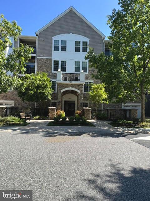 Welcome to 7201 Travertine Drive, unit #404!  A beautifully maintained fourth-floor condominium in the highly desirable Highlands at Quarry Lake, offering comfortable one-level living with elevator access and a thoughtfully designed floor plan. 

The inviting living room and formal dining room feature rich hardwood flooring, creating an elegant space for everyday living and entertaining. The spacious kitchen is appointed with hardwood flooring, granite countertops, white appliances, and a sunny breakfast area. Just off the kitchen, the family room also showcases hardwood floors and opens through a sliding glass door to a private balcony overlooking the peaceful courtyard. 

The generous primary suite offers plush carpeting, a large walk-in closet plus a second closet, and a private en-suite bath with a dual vanity and walk-in shower. The second bedroom also features carpeting, a walk-in closet plus an additional closet, providing ample storage. A full hall bath includes ceramic tile flooring, a single vanity, and a tub/shower combination. Completing the home is a convenient laundry room for daily tasks and chores. 

Enjoy low-maintenance living in a sought-after community with exceptional amenities including a walking/jogging path, fitness center, community center, outdoor pool - all just moments from Quarry Lake's shopping, dining, and major commuter routes. Come take a look today and make this beautiful property yours!