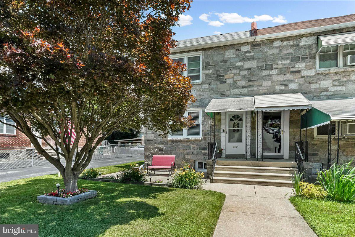 This beautifully maintained, move-in-ready home checks all the boxes! Situated in a desirable location, this charming stone-front property welcomes you with a shaded front patio beneath a stunning red maple tree.
Step inside to find a spacious living room that flows seamlessly into the open-concept dining area and kitchen. Gorgeous hardwood floors extend throughout the first floor, creating a warm and inviting atmosphere. The dining room offers ample space for gatherings, while a wall air-conditioning unit efficiently cools the entire level.
The updated eat-in kitchen is a true standout, featuring an abundance of white cabinetry, soft-close and pull-out drawers, beautiful granite countertops, and a large custom island with additional seating. Appliances include a 5-burner gas range, dishwasher, garbage disposal, and refrigerator. Recessed lighting adds the perfect finishing touch to the kitchen and dining areas.
From the kitchen, you'll find convenient access to the expansive backyard—ideal for summer barbecues, entertaining, and outdoor enjoyment.
Upstairs, the spacious primary bedroom features double closets, a ceiling fan, and a wall air-conditioning unit. Two additional generously sized bedrooms each include ceiling fans, and window air-conditioning units will remain with the home. A large full bathroom with tile flooring and tiled bath surround completes the second floor.
The semi-finished basement offers additional living space, a convenient powder room, and an exterior exit through Bilco doors leading to the backyard.
Additional improvements and features include:
• Replacement windows within the last 10 years
• New gas hot water heater (2026)
• Gas heater approximately 10 years old
• Flat roof replaced in 2018
• Driveway parking for up to 4 vehicles
• Detached 1-car garage
All of this is conveniently located within walking distance of shopping, public transportation, and the brand-new middle school currently under construction.