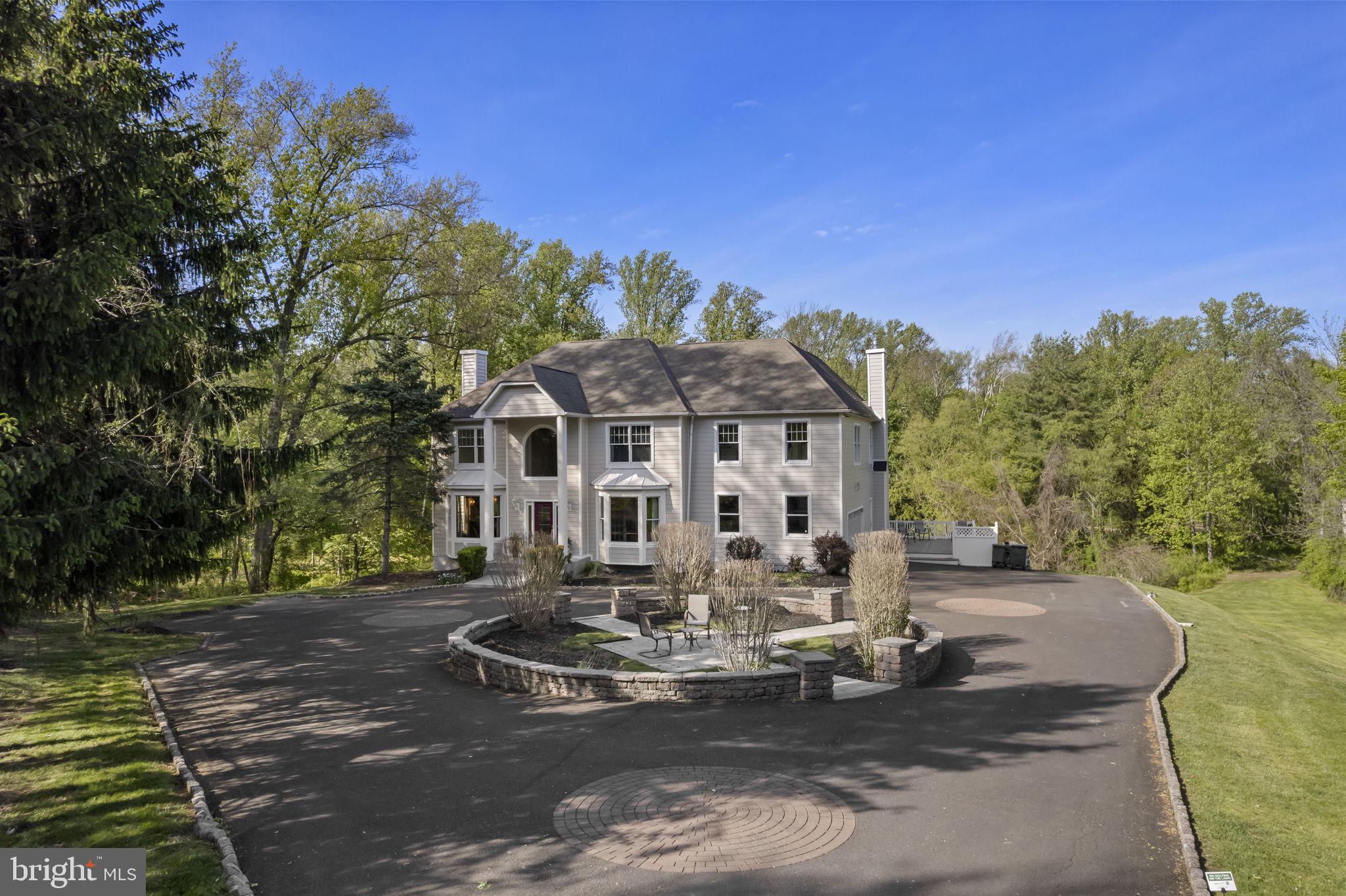 Welcome to your private oasis—perfectly positioned in the heart of convenience. Nestled at the end of a private road on a premium 3.24-acre parcel, this custom Colonial offers exceptional privacy, space, and timeless design. On a Flag Lot. 

Lovingly maintained and thoughtfully updated by the original owners, the home is surrounded by professionally landscaped grounds, a custom stone front patio, ambient lighting, and expansive decking that overlooks serene, wooded views. All surrounded on three sides by a Land Conservancy.  Private!

Step inside to a dramatic two-story hardwood foyer with staircase featuring new carpet runners. Just off the entry is a private home office with custom built-ins and glass doors. The formal living room with attractive mantel and  fireplace and elegant dining room—complete with wainscoting and chair rail—are ideal for both everyday living and entertaining.

The rear of the home' Main Level opens to a warm and inviting Family Room with fireplace, a Palladian window framing peaceful wooded views, and access to a convenient back staircase. The home is enhanced throughout with custom moldings and detailed millwork.

The updated kitchen features hardwood flooring, expansive countertops and tile, and a sunlit breakfast area with a custom sectioned wood built-in table, all flowing seamlessly into the family room and overlooking the expansive rear grounds. A powder room and a well-appointed laundry/mudroom with abundant cabinetry complete the main level.

Additional highlights include a 2+ car side-entry garage with epoxy flooring and updated doors, repaved driveway, and an elevated side deck for outdoor enjoyment.

Upstairs, you’ll find four spacious bedrooms, including a luxurious primary suite with sitting or workout area, custom moldings, and generous closet space. The en-suite bath offers ceramic tile flooring, a corner Jacuzzi tub, separate shower, dual vanities, and linen storage. Bedroom two includes a private bath, while bedrooms three and four share a hall bath. All bedrooms and baths have been freshly painted with new carpeting.

The full walk-out basement offers high ceilings, abundant natural light, and endless potential for finishing, along with direct access to the rear grounds.

Outdoors, enjoy your own private tennis court—recently resurfaced and ready for use—along with the peaceful natural setting that defines this property.

Recent upgrades include HVAC, hot water heater, custom front door, repaved driveway, and Hardie Board siding.

Located in the highly sought-after Northampton Twp and Council Rock School District, this exceptional home combines privacy, quality, and location in one truly special offering in Holland PA

Schedule your private tour today.