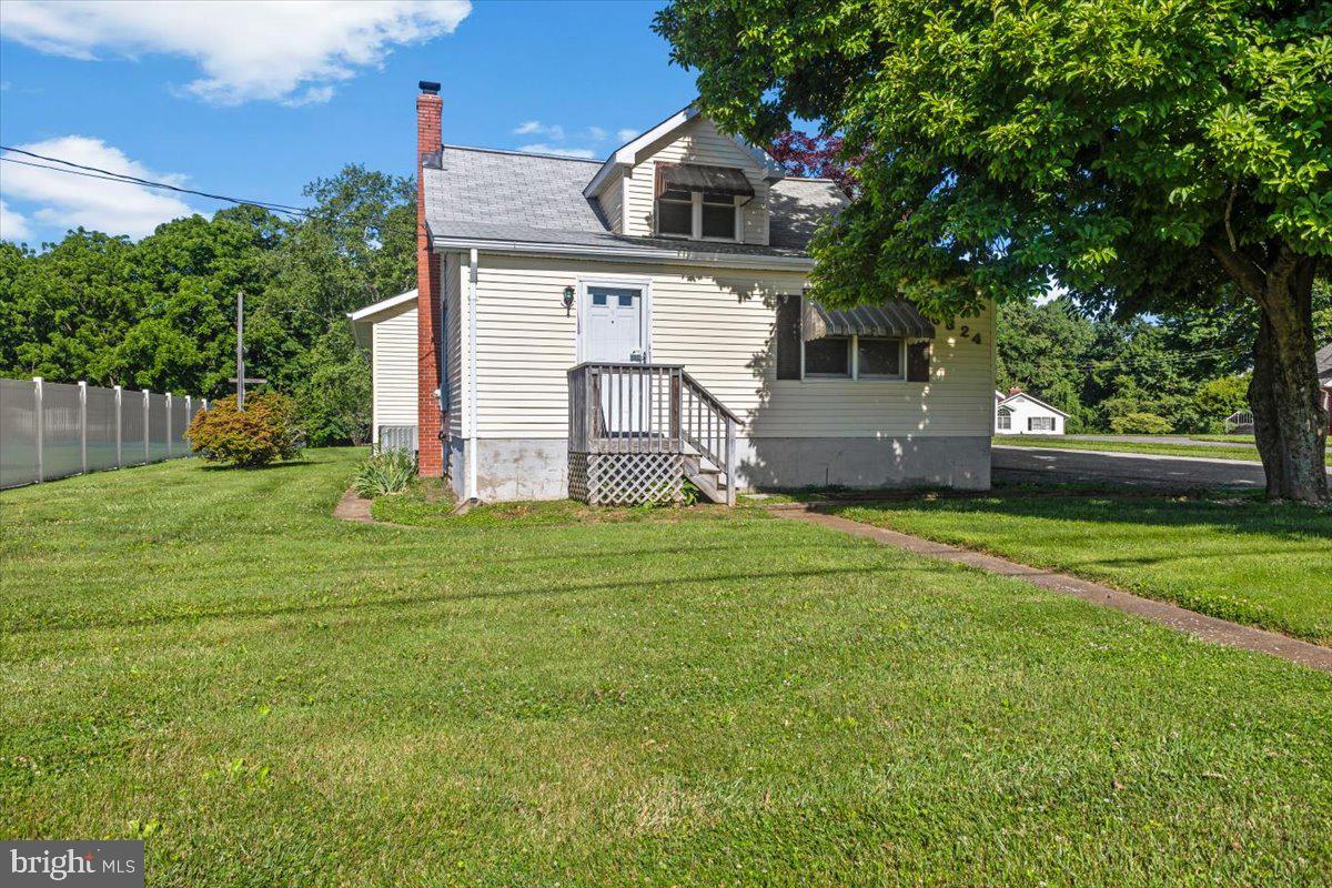 Multiple offers received. Highest and best offer deadline Tuesday June 9th 6:00pm.  Charming Cape Cod in Woodbine with gorgeous rural views of farmland. The property features a detached 3-car garage and a level, private backyard that backs to mature trees, offering a peaceful outdoor setting. Approximately 1,765 sq. ft. of living space. Inside, a main-level primary bedroom with a walk-in closet is joined by a second bedroom and two full bathrooms on the main level. A spacious third bedroom is located on the upper level. The main level offers a spacious kitchen, comfortable living room, and convenient laundry area. Features include fresh paint throughout, Trane heat pump, roof shingles (approx. 5 yrs. old), electrical panel box updated in 1987, recently installed sump pump and well pressure tank, and a regularly serviced water treatment system. Convenient to shops and restaurants, with a commuter-friendly location near Mount Airy, Eldersburg, Frederick County, and Howard County. Nice condition, sold as is.  Professional photos coming very soon.