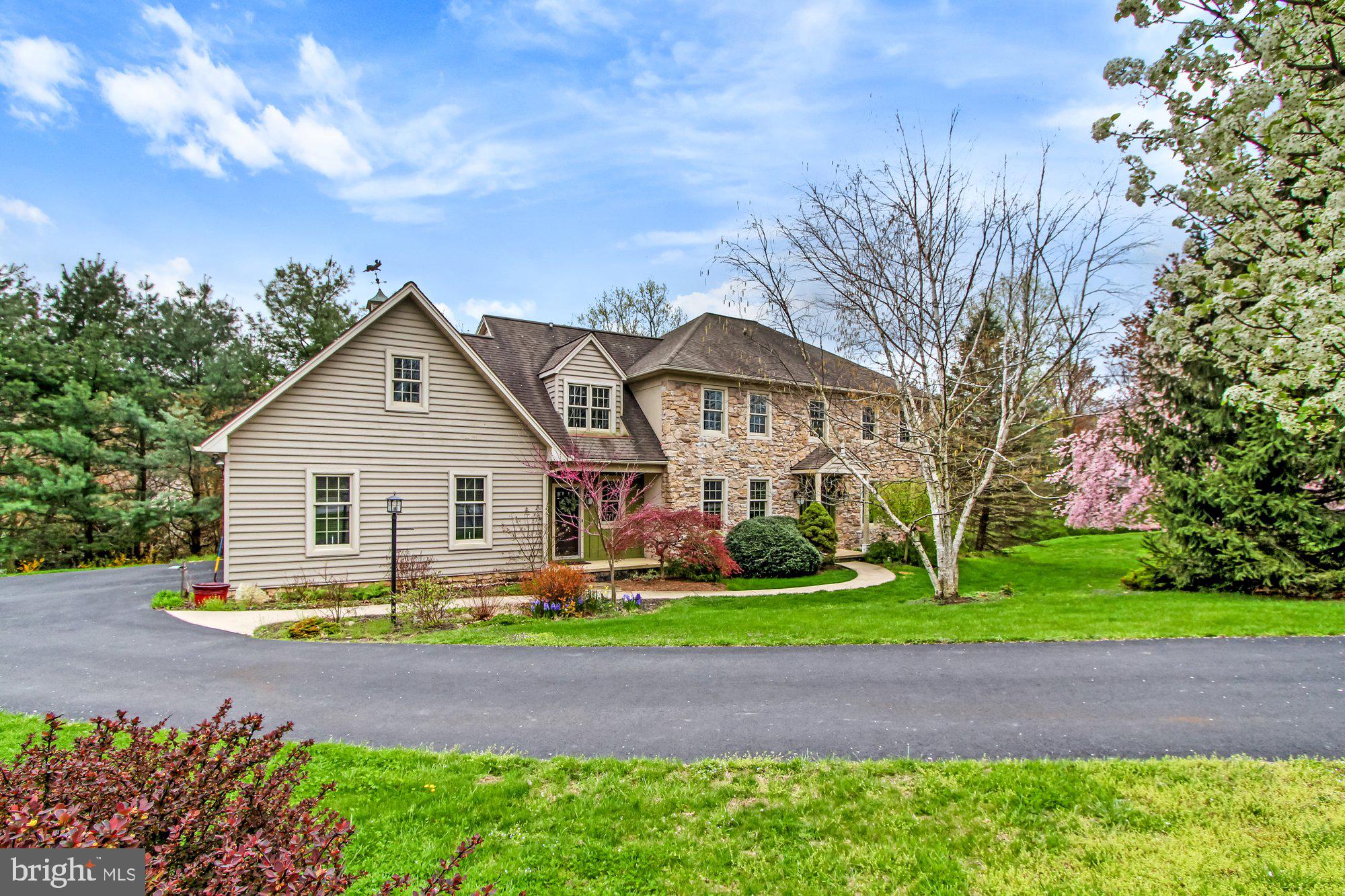 Fall in love with this beauty on over an acre by Rocky Ridge Park. In the spring you'll be inspired by the beautiful blooming cherry trees & serene setting. Walk into an open Foyer w/formal Living Room to the right & formal Dining Room to the left. Both have wainscotting, chair rail & crown moldings. Engineered wood floors throughout main level (except FR), 9' ceilings, spacious kit w/granite counter island & quartz countertops, maple cabinets, double oven (top is convection/microwave oven) & all appliances convey. Between the Kitchen & formal dining is a Butler's Pantry w/Wet Bar & cabinets.  The kitchen is open to the Family Room that features a stone wood burning fireplace w/blower, recessed lighting & pocket doors that lead into the formal living room.  There are Anderson windows & a sliding glass door on the back of the house leading out to a large 28x12 composite deck.  Great outdoor space for entertaining with privacy & woods.  The office is on the main level has its own private entrance. There are 2 laundry hook-ups, one on the 1st level & one on the 2nd.  There are 5 generous Bedrooms with choice of primary; one w/nook for reading or relaxing, walk-in closet & large Bath w/dual pedestal sinks. Second primary is at the other end of home w/skylights, 2 closets, Full Bath & Laundry.  The 3rd Full Bath has a whirlpool tub, dual sinks & bamboo flooring. (See agent remarks) Huge unfinished walk-out basement offers lots of possibilities for future expansion: partial stone wall & flue for fireplace or wood stove & rough in for bath. Two heating & AC units updated with 2 zones for your comfort during the winter & summer. Hybrid security system in home. There is A LOT to love with this unique property. Enjoy living next to the beautiful Rocky Ridge Park yet only minutes to Rt 30 & all East York conveniences! Take a look today. (No sign on property)