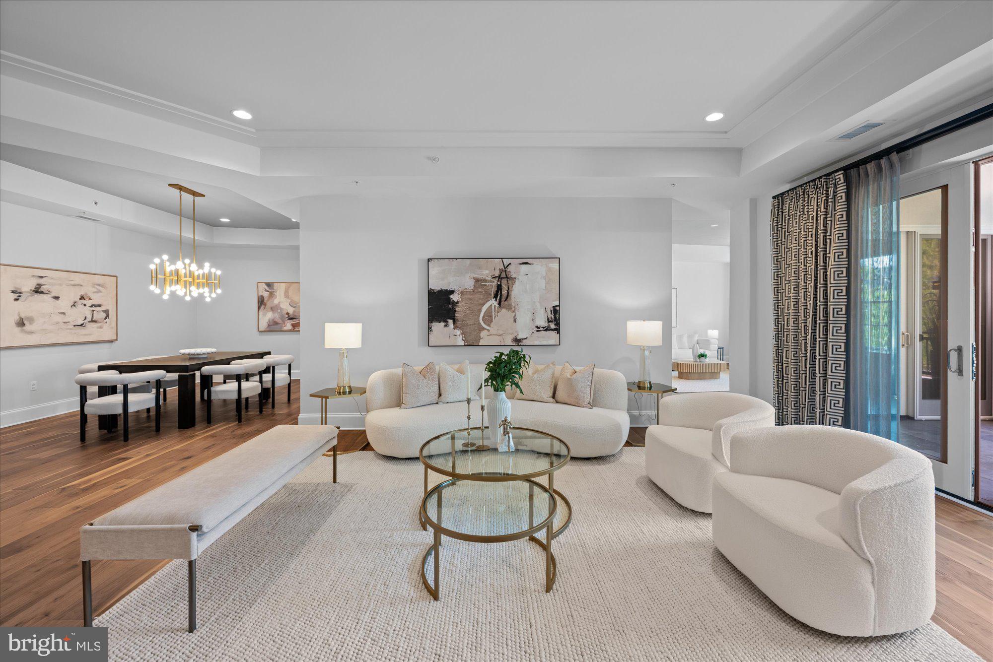 Presenting the pinnacle of luxurious living: the  Builder's model at the exclusive Quarry Springs. Positioned in a serene enclave at the rear of this resort-style community, the residence is enveloped by meticulously landscaped gardens, a cascading waterfall, a picturesque gazebo, and a pristine pool. "The Montrose" floor plan offers an expansive 2,700 square feet of unparalleled interior living space, complemented by an additional 440 square feet of private, covered terraces that boast sweeping courtyard and pool vistas.
Arrival is a grand experience, with a private elevator opening directly into a magnificent foyer. The eye is immediately drawn to the premium 7-inch EcoTimber hardwood plank flooring and substantial 10-inch base moldings that anchor the space. Bespoke details abound, including lavish designer lighting fixtures, custom illuminated cabinetry, and a stately mantled gas fireplace. Elegant tray ceilings with recessed lighting further accentuate the impressive vertical volume throughout the home. From the adjoining formal living and family rooms, seamless access is granted to the first of two expansive covered terraces.
Offering two generously proportioned bedrooms, two and a half luxuriously appointed bathrooms adorned with custom designer wallcoverings, and a versatile family room, this residence represents the very quintessence of elegance. It is situated within a highly secure, gated Bethesda community, where residents enjoy the utmost privacy and exceptional service, including a dedicated gatekeeper, personal concierge, and doorman. Exclusivity is guaranteed, as Building Four is an intimate enclave comprising merely 24 units.
The culinary center is a masterpiece of both form and function. A true chef's kitchen, it features sleek, designer white Woodmont-style cabinetry by the Suss Group, beautifully contrasted by exquisite marble countertops. The suite of professional-grade appliances leaves nothing to be desired: a 42-inch Sub-Zero refrigerator, a 30-inch five-burner Wolf gas cooktop with an exterior-venting range hood, a 30-inch Wolf convection oven, a 24-inch Wolf convection microwave, and a discrete Sub-Zero under-counter wine and beverage preservation center. The space is flawlessly completed by a Bosch dishwasher, a stainless steel Waterworks faucet, and a Blanco under-mount sink.
The primary owner's suite is a private sanctuary, offering direct access to the second covered terrace and featuring expansive, custom-built closets. The accompanying en-suite bathroom is a spa-like retreat, boasting an oversized walk-in shower, a freestanding Waterworks soaking tub, and a dual-sink vanity swathed in pristine Carrara marble, all complemented by premium Waterworks and Toto fixtures. The secondary bedroom is equally inviting, featuring exquisite designer wallcoverings, access to the terrace, and a private en-suite flawlessly finished with high-end Waterworks and Toto accessories.
Practicality meets elegance in the dedicated laundry room, outfitted with pristine white cabinetry and an oversized washer and dryer. This space conveniently connects to a private rear service entrance, ideal for discreet personal deliveries. Adding to the effortless living experience, Unit 423 conveys two assigned parking spaces and a dedicated storage unit within the immaculate, secure underground parking garage.
Residents are afforded an unparalleled lifestyle with comprehensive amenities, meticulous custodial maintenance, high-speed internet, on-site management, and snow removal. The community features a state-of-the-art health club, beautifully manicured gardens, and expansive recreation and club facilities. Superbly located just blocks from major thoroughfares, with effortless access to Washington D.C., N.Virginia, and three international airports. Furthermore, enthusiasts will appreciate being less than 3 miles from the prestigious Congressional, Burning Tree,  Avenel & Bethesda Country Clubs