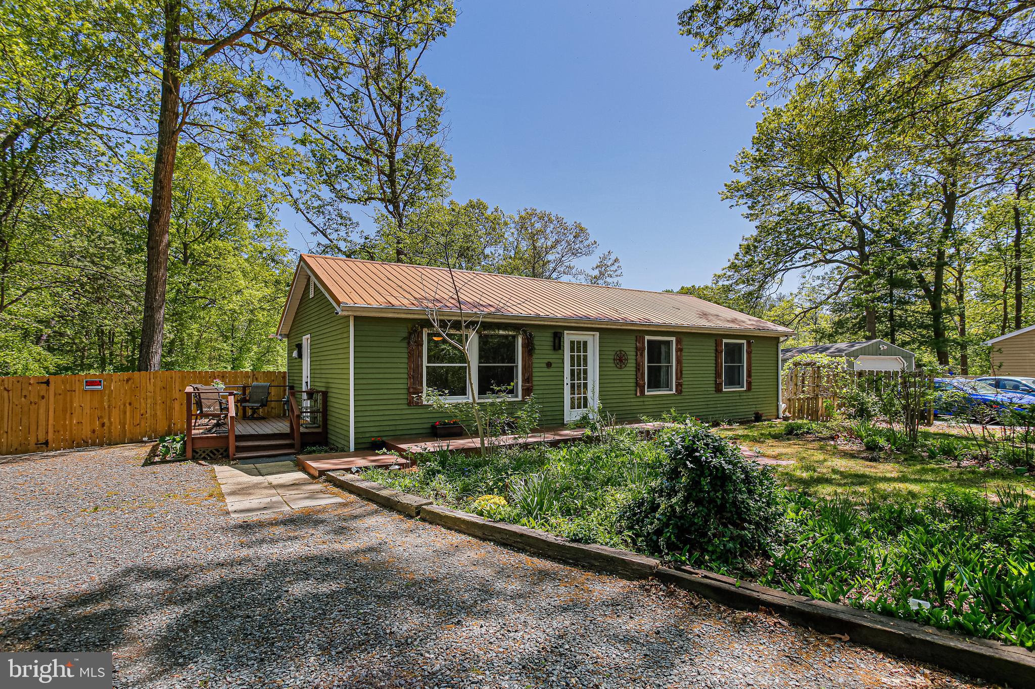 -Final/best offers are due by Saturday, May 3rd at 4pm!!!! Charming 3 bedroom, 2 full bath ranch in North East!  This lovely ranch-style home offers 3 spacious bedrooms and 2 full bathrooms, perfect for comfortable living.  The main level also boasts a living area full of natural light and a cozy eat in kitchen. The kitchen features exposed upper shelving and butcher block countertops.  Finished lower level provides extra square footage with a living area, full bathroom, snack bar and space for bonus room or office.  Also features an unfinished storage and laundry area.  Step out the door upstairs and enjoy the outdoors with mature fruit trees, concord grapevines and seasonally satisfying flower gardens in front & raised beds for vegetables in the back.   You will also find two sheds accompanied with electric and heat for those chilly nights. The potting shed also has air conditioning. Fully fenced in backyard adds additional privacy. Additional parking pad in the back of the house. Basement work completed in 2024 by Basement Guru to include adding a French drain, an additional sump pump, triangular drainage 20 ft from the house which includes the sump pump lines and the AC condensation line.  Remodeled basement and raised ceiling height from drop ceiling to drywall. Rewired electrical box and made all outlets GFI in 2023. Washer (2024), Hot water heater (2021), RO water filtration system (2022), Fence (2024), Refrigerator (2021), Garbage disposal (2022), Gutter guards (2023) ceiling fan guest room (2024).  This home is located on a quiet cul de sac just minutes from shopping,  restaurants, the NE town park and downtown North East. Don't miss out on this lovely rancher! Home being sold as is!