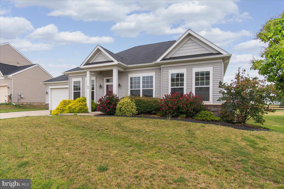 Welcome home to 85 Liverpool Lane in Martinsburg!
Driving up to the home you will notice the charming curb appeal of this 3 bed 2 bath rancher, just 12 years young. Upon entering the home, you’ll notice the gleaming hardwood floors. A formal dining area is located in the front of the home off the kitchen. Once in the kitchen there you’ll be immersed in the open concept bright and airy living space. The kitchen offers a large kitchen island with extra prep space and additional seating. This modern living space includes a cozy fireplace, which currently has an electric insert, but can easily be converted back to the original wood burning feature. The spacious master bedroom includes a walk-in closet and en suite bathroom with whirlpool tub, separate shower and double vanity. The two other bedrooms feature carpet and large windows. A rear patio is awaiting your green thumb and landscaping dreams for a perfect outdoor oasis. New HVAC and hot water heater in Feb 2023.
