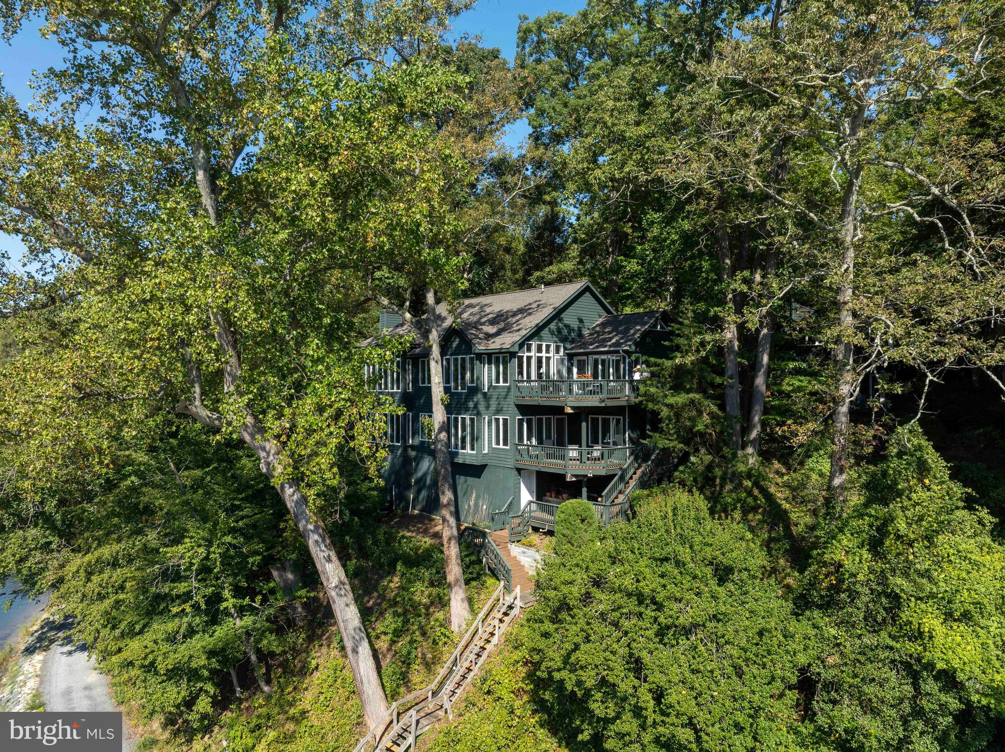 **Large Waterfront Listing now available in Sherwood Forest!!** 

606 Maid Marion Hill is one of the roomier homes in Sherwood Forest.  Enter at street level and you are welcomed into a living room with a vaulted ceiling and tall windows affording a 180* WATER VIEW , reminiscent of a grand tree house.  To the right of the spacious entryway which includes a convenient powder room, you enter the NEWLY RENOVATED kitchen, off of which, is one of three decks - perfect for your barbeque.  The deck also has an entrance to the mud/laundry room, conveniently located off of the kitchen.  Opening from the kitchen, also with a vaulted ceiling, is the cozy sitting room - again with tree house vistas, but with a wood burning fireplace.  Back through the living room, is the entrance to a spacious deck looking up Brewer Creek toward the Severn River.  On this level is the primary bedroom and primary bath with, shower and double vanity.

Proceed to the lower level - and you are greeted by a spacious family room and dining area, surrounded by tall windows and water views throughout.  A double door closet houses an under counter fridge and sink.  Three more bedrooms and another deck make this level feel like it's own apartment!  Under this level, accessed from the outside staircase, is an unfinished basement area, great for storage of your bikes, tubes, kayaks and other recreational equipment.  

**Sherwood Forest is a gated Community of 341 homes, situated on the Severn River.   It's peninsula shape and sweeping elevations create gorgeous vistas of the surrounding creeks, river and the Severn River Bridge. 

**Walk along the 2 mile waterfront road and take in bridges framing the mouth of the Chesapeake Bay.

 **Bike or hike the 5 miles of outer Forest trails.  Most residents prefer their Golf Carts for easily navigating the scenic hills.

**Established in 1915, the Community is anchored by a grand nostalgic Clubhouse which overlooks the Community Pool - and houses a Dance Hall, Duckpin Bowling Alley, a Stage for Community Productions, a Grand Stone Fireplace, Library, and a Nature Lab for educating the children about Chesapeake life.  Members enjoy many events at the Clubhouse including Community Dances, Anniversary Celebrations, and Cultural Arts Presentations.  The Clubhouse is available to members to rent for Weddings or Private Events.

** The Sherwood Forest Market serves ready-made meals and stocks staples for your cottage kitchen. 

** Sherwood is known for the Children's Summer camp where your children learn numerous activities including Sailing, Swimming and Archery. 

**Other outstanding amenities are a 9-Hole Golf Course, Tennis Courts, Pickleball Courts, Basketball Court, Badminton, Softball field and a Lacrosse/Soccer field.  

** For the Chesapeake lovers, Sherwood has a Marina, a , Small Piers and a Main Pier where river swim meets are held. 

**Make memories with events like the 3rd of July Fireworks, 4th of July Parade and and Annual "not be be missed" Corn Roast.  There are tennis, golf and pickleball tournaments for adults and children alike.

*With a purchase of a home, Sherwood Forest requires a one-time $20,000 club membership fee.