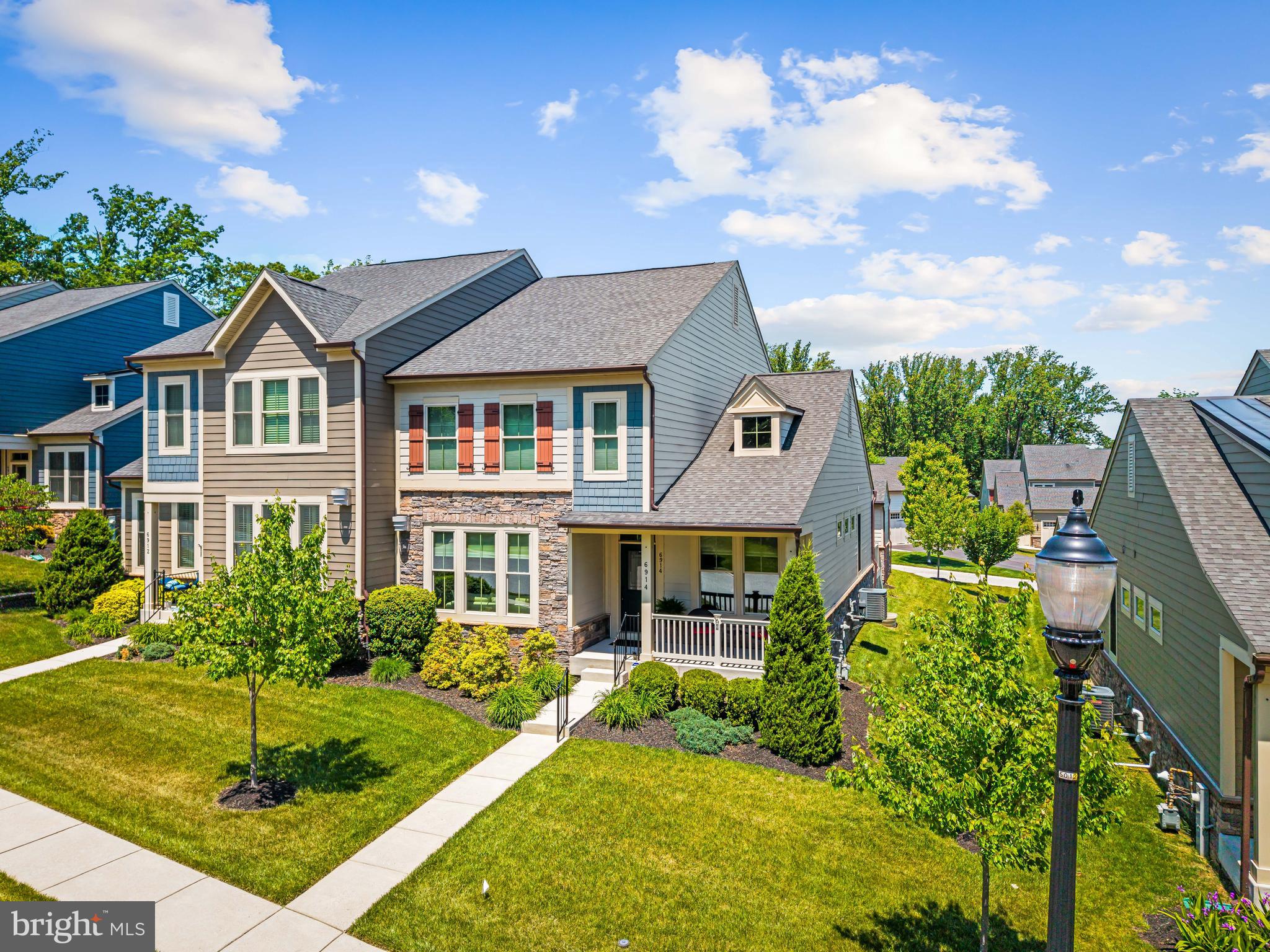 Welcome to one of the rare opportunities in Stoneleigh Summit, Towson’s only gated 55 plus villa home enclave. Perfectly positioned between the highly sought-after Stoneleigh and Maxalea areas and close to Ruxton, this exceptional residence combines elegant design, low-maintenance living, and a premier golf course setting within an intimate gated community of just 36 homes. From the moment you arrive, the home’s curb appeal stands out with Hardie Plank siding, natural stone accents, a covered front porch, a side deck, oversized driveway, two-car garage, and dedicated golf cart bay garage. Designed for effortless main-level living, the home features a spacious primary suite with a luxurious bath, double vanity, walk-in shower, and expansive walk-in closet. A convenient coat closet, half bath and laundry area are located just off the attached garage. Making this home unique within the neighborhood, 6914 Summit Circle has an enclosed porch, allowing for three and a half seasons of enjoyment and overlooks community-maintained grass and tree area. Soaring 9-foot ceilings and an open-concept layout create bright, inviting living spaces throughout. At the heart of the home, the gourmet kitchen is beautifully appointed with granite countertops, stainless steel appliances, double ovens, separate cooktop, built-in microwave, abundant cabinetry, and an oversized island with breakfast bar seating — ideal for entertaining or everyday living. The dramatic two-story living room showcases custom built-in cabinets and bookshelves framing a picturesque gas fireplace.  Upstairs, a versatile loft gathering area accompanies two generously sized bedrooms with walk –in closets, a full hall bath, and additional storage space — offering flexibility for guests, hobbies, or home office needs. The fully finished lower level expands the home’s functionality with a spacious family room, beautifully designed wet bar with seating, an additional bedroom with large closet and a full bath — creating the ideal retreat for overnight guests. Don't miss the full workshop space, with two workbenches and plenty of room for tool storage, shop equipment, and hobby space. Residents of Stoneleigh Summit enjoy a truly turnkey lifestyle with HOA services that include lawn care, landscaping, and snow removal. Adjacent to Country Club of Maryland with direct golf cart access, the community overlooks manicured fairways and wooded preserves while offering convenient access to golf, dining, and recreation for those seeking membership opportunities. Tucked away in a peaceful setting yet just minutes from downtown Towson shopping, dining, premier medical centers, and universities, this exceptional home offers the perfect blend of luxury and convenience in one of the area’s most desirable communities.