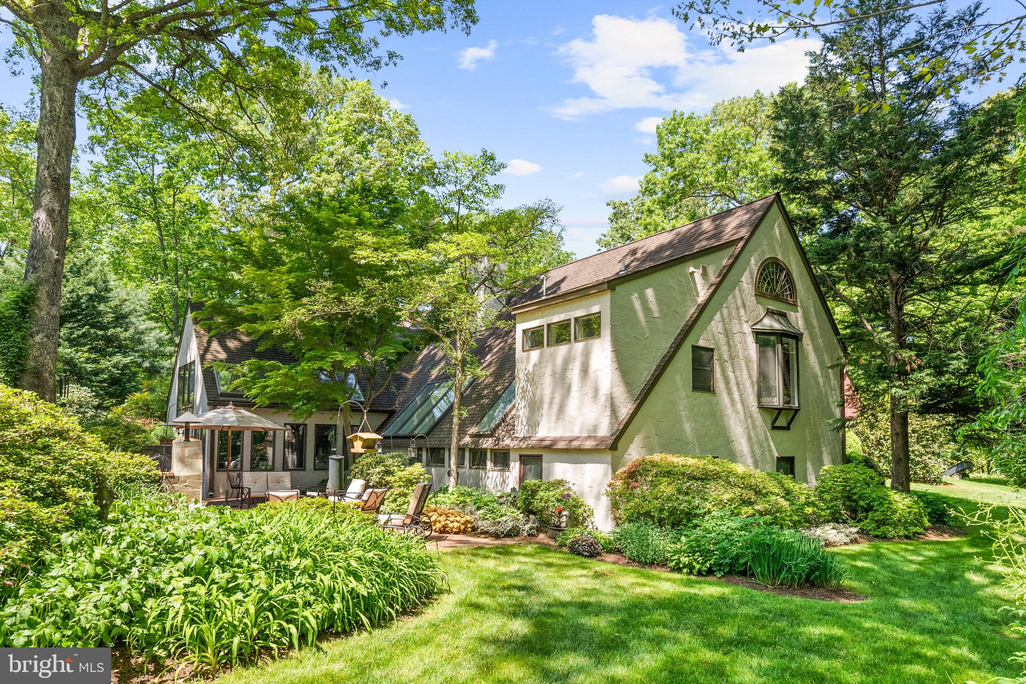 This exquisite, custom, post & beam home sits on nearly 5 sprawling acres, at the end of a cul-de-sac, in beautiful Mazza Woods of Potomac. 7211 Brookstone Court was completed in 1985 and has been updated & maintained by one meticulous owner. A perfect marriage of architectural and design styles, this pristine and unique home must be toured in person. It features 5 bedrooms (in three different suites) and 3.5 bathrooms.

Enter the solid wood, arched doors into a grand foyer with masterfully “faux” painted walls and imported Mexican tile underfoot. The cathedral ceilings and exposed beams will take your breath away. French doors, myriad skylights, and expansive, arched windows invite the sun and nature inside to highlight each spectacular detail. The main level is the heart of this home, perfect for entertaining with its open-plan living room (complete with centerpiece wood-burning fireplace), beautiful dining area, and knotty pine floors. 

An addition in 1998 brought the kitchen as a hub for gatherings with its high-end appliances, heated floors, spacious dining area & island, interior garden, and separate Butler’s Kitchen (remodeled in 2019) - perfect for caterers when hosting large events. The large patio is accessible directly from the kitchen and showcases both a built-in grill and fireplace. Flowing from the kitchen is the cozy family room with wood-burning stove and home office with built-in desk and shelves. Up one half-level from the office (and also accessed from the main level living space) is the alluring Primary Suite with a bay window, wall to wall closets, and en-suite bath with dual vanities & walk-in spa shower. 

On the North side of the home, above the garage, is another bedroom suite, complete with its own living area and full bathroom. On the lowest level is the final bedroom suite, featuring 3 bedrooms, a full bathroom, and another quaint living space. 

The private, 4.78 acre lot is abundant with gardens, filled with azaleas, rhododendron, and other native, flowering plants. Wherever you turn, you are greeted with color and delight. Neither “unique” nor “rare” seem to exactly describe the way this residence lovingly welcomes you in, you have to experience it for yourself.