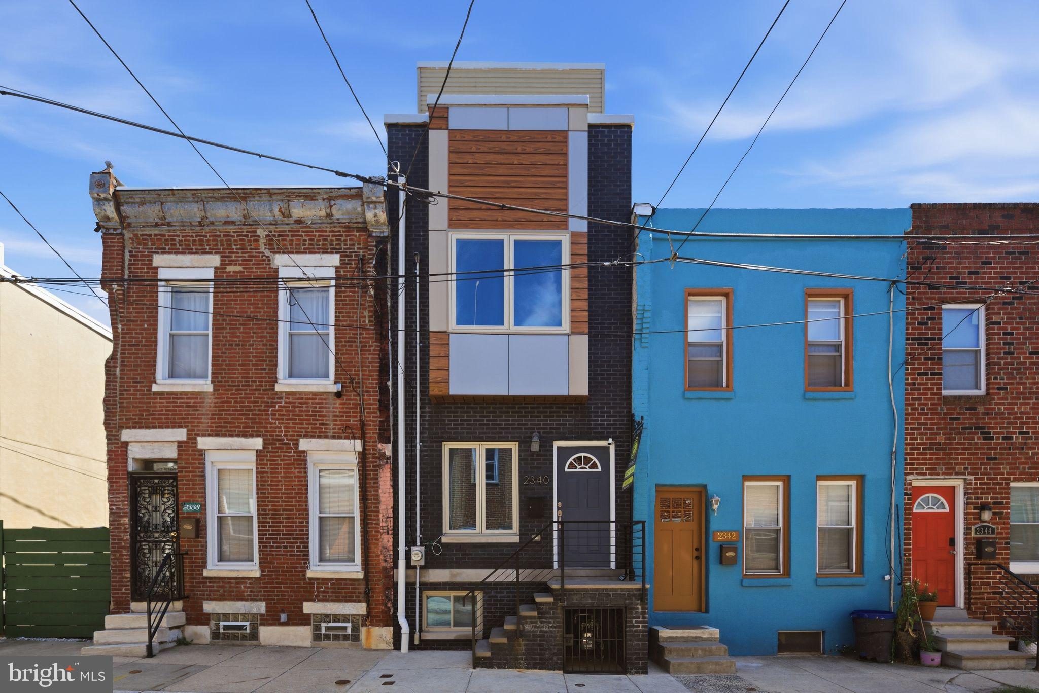 Beautifully maintained newer-construction home on a quiet and friendly block in Point Breeze offering 3 bedrooms, 2.5 bathrooms, three private outdoor spaces, and Center City skyline views. This home provides modern living with a practical layout and low ownership costs thanks to the remaining tax abatement. The main level features an open-concept living, dining, and kitchen area with plenty of storage, natural light, along with a convenient powder room. Decorative moldings throughout add character and elegance. A large rear patio provides an excellent space for outdoor dining, grilling, gardening, or entertaining. The second floor includes two spacious bedrooms and a large full hall bathroom, with one bedroom featuring a Juliet balcony. The primary bedroom offers an en-suite bath and large private patio. Closets throughout the home provide excellent storage. The finished basement adds valuable living space and includes a laundry area and additional storage. The rooftop deck offers impressive Center City skyline views and plenty of space for entertaining or relaxing. Situated on a quiet block just two blocks from Wharton Square Park, the home is a quick stroll to all the shops along Washington Avenue, including Dock Street Brewery, Breezy's, Porco's, CVS, Aldi, and other favorites. SEPTA is footsteps away, providing a quick access to Center City and University City. The home shows even better in person with real staging.