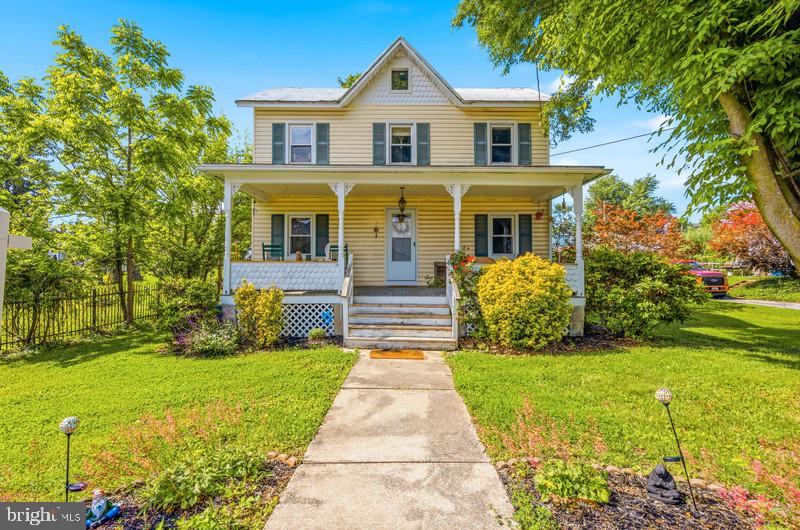 The beauty of this 1899 Victorian Style Colonial offers unique historic charm, with thoughtful updates throughout. Whether it’s sipping your morning coffee or evening relaxation, the full covered front porch is the perfect outdoor living space. As you enter, you will find beautiful oak hardwood flooring throughout the living and dining rooms that was just professionally refinished about a year ago. The perfectly designed kitchen is complete with 42” cabinets, stainless farmhouse sink, a Quartz center island with generous culinary space, JennAir stove/oven, stainless steel appliances, and durable, wide plank, luxury vinyl stone look flooring.  The oversized laundry room is conveniently located off the kitchen. Upstairs has easy-care, engineered hardwood flooring that flows perfectly into the beautiful en suite bathroom, with new vanity, toilet, shower, and custom-designed shower doors. Exit the kitchen onto the large Trex-style deck overlooking a level fenced yard with a spacious shed for your outdoor storage needs. This is the perfect place to call home for small-town living with all the modern conveniences, located in the beautiful town of New Windsor, approximately 10 minutes from Westminster.