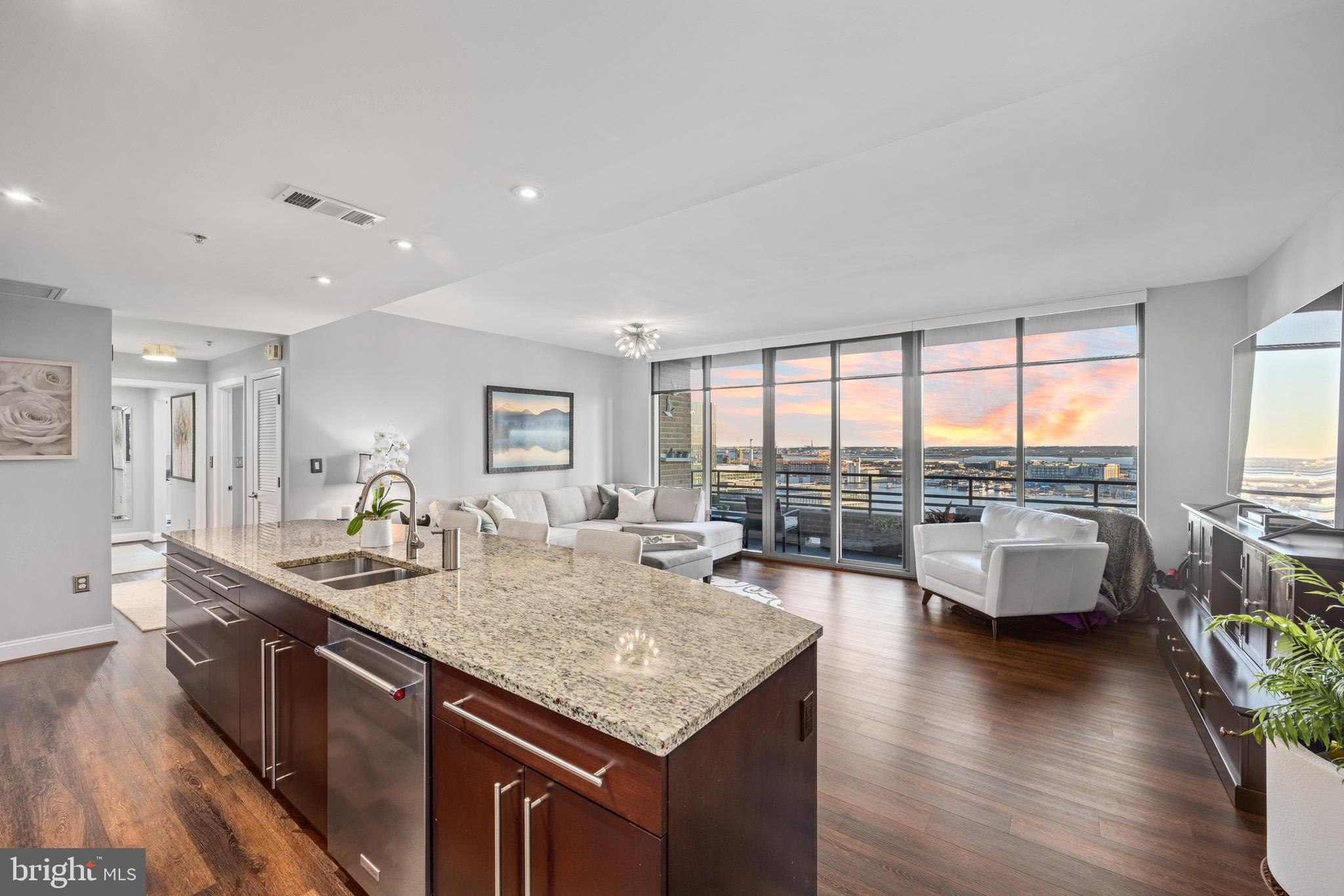 Extraordinary two bedroom two bath corner residence high on the 25th floor of The Vue condominium in the heart of Harbor East. This rarely available water facing condo offers breathtaking vistas of the Patapsco River and dramatic cityscapes from every room. Featuring an open floor plan with floor-to-ceiling windows,  automated blinds, gourmet kitchen with expansive kitchen island, custom backsplash and a private balcony. The stunning primary suite features floor to ceiling corner windows, an oversized custom walk-in closet, and spa bath with a soaking tub, glass-enclosed shower and double bowl vanity.  One covered parking space is included with this offering. The Vue condominium is located in Baltimore's prime neighborhood within steps to the finest restaurants, boutique shops, Whole Foods, Starbucks, the Inner Harbor, waterfront and nightlife. The Condo fee covers AC, heat, water, security and concierge. Take the elevator directly to the MAC gym and Harbor East Cinemas.