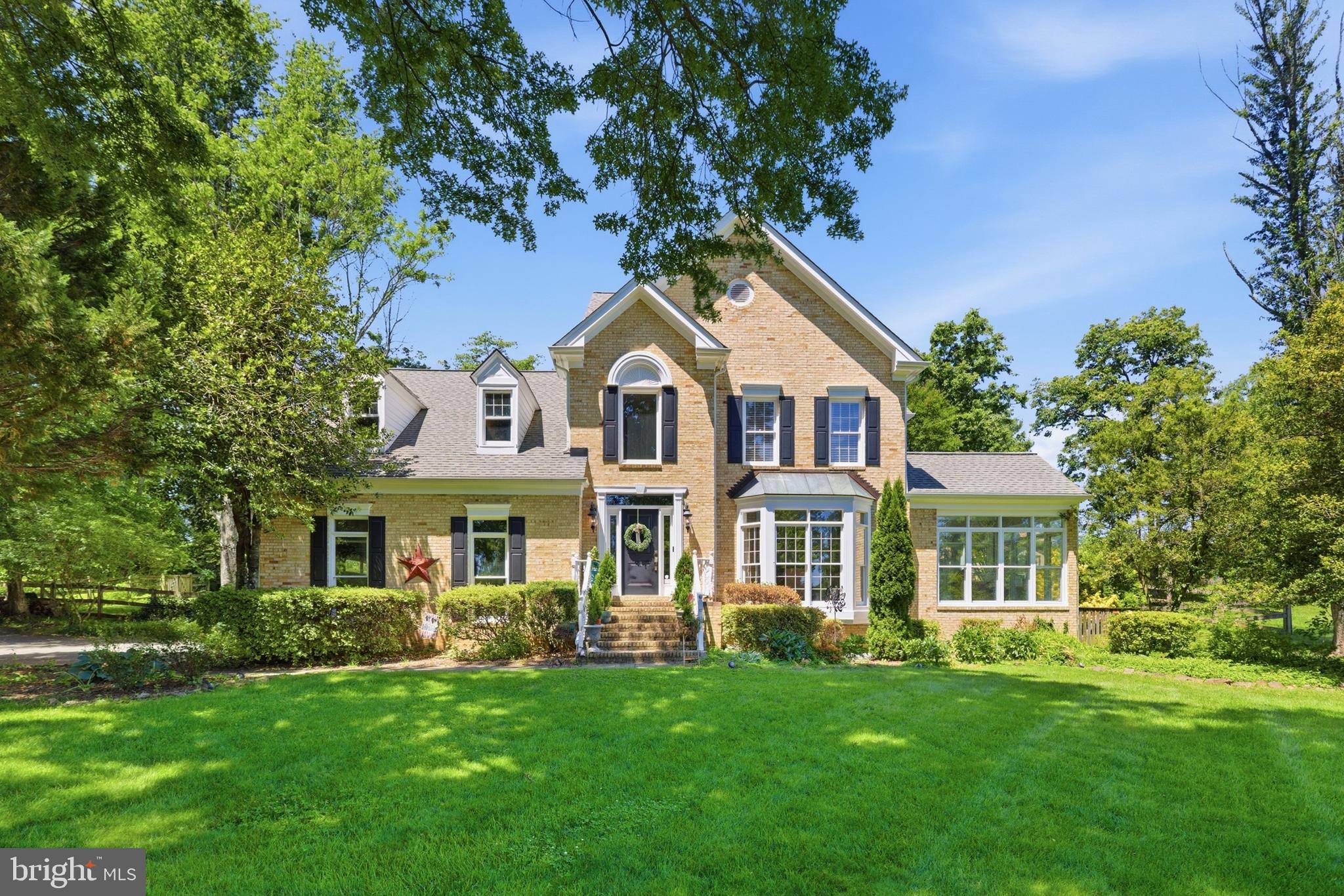 Extraordinary custom residence offering stunning curb appeal, mature and extensive landscaping, a brick walkway, and an incredible private backyard retreat designed to feel peaceful, luxurious, and inviting. Walk into your private retreat in this luxurious fully-fenced backyard surrounded by trees and enhanced by extensive hardscaping, stacked stone retaining walls, a serene stone water feature, expansive flat grassy space, and a massive brick patio with a stone firepit designed for both entertaining and everyday relaxation. This one-of-a-kind property is filled with timeless character, warmth, and architectural charm rarely found in today’s homes.

Inside, soaring two-story ceilings, a grand curved staircase, dramatic rooms, and walls of windows create an unforgettable first impression while flooding the home with incredible natural light from nearly every angle. Floor-to-ceiling windows overlooking the breathtaking backyard retreat line the rear of the home, creating stunning views throughout the main living spaces. Rich hardwood floors flow throughout the main level while elegant formal living and dining spaces, a stunning family room with soaring ceilings and wood-burning fireplace, and a sunroom filled with natural light make every space feel elevated, warm, and inviting.

The updated kitchen features granite countertops, floor-to-ceiling cabinetry, a spacious island, a smart refrigerator, private dining nook overlooking the serene backyard views, and a butler’s pantry connecting the kitchen and formal dining room. The main-level primary suite serves as a true private retreat and oasis with oversized windows overlooking the tranquil backyard setting, a customized and spacious en-suite bath with high-end tiling, reformation fixtures, soaking tub and stone enclosed  shower, and walk-in closets. The upper level features expansive secondary bedrooms with walk-in closets and beautifully updated bathrooms.

The finished lower level offers an expansive recreation room with durable LVP flooring, granite bar with built-in kegerator, private den, attached full bathroom, and a large storage room. Additional highlights include updated lighting throughout, a main-level laundry room with feature brick accent wall, soaring garage ceilings, and a spacious layout designed for both entertaining and everyday living. Major system updates include main HVAC system (2025) and second HVAC system (2024).

Conveniently located near shopping, dining, commuter routes, parks, wineries, and top local amenities while still offering an incredibly private setting.
