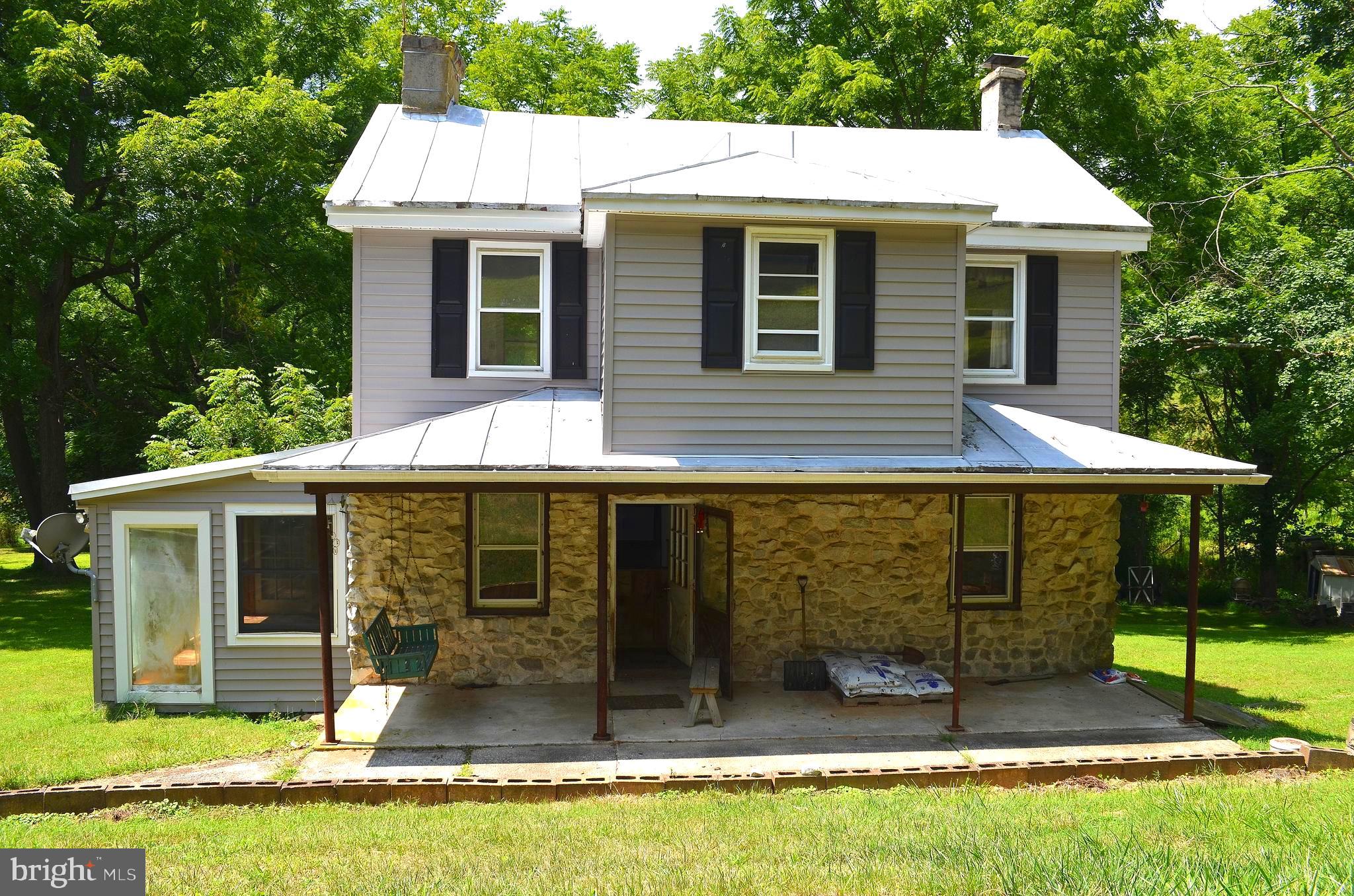 Charming 1876 Farmhouse on 7.25 Acres – Fixer-Upper with Endless Potential!

Nestled in a serene, private setting, off the beaten path - this 3-bedroom, 2-bath farmhouse is brimming with yester-year charm when life was simple.... It is ready for your personal touches, this fixer upper could be your private get away. Featuring a spacious eat-in kitchen, sunroom with soaking tub, and a cozy living room with a pellet stove, this home offers plenty of character. Enjoy peaceful mornings on the deck overlooking the countryside. 

The property includes a large outbuilding with electric and heat—perfect for a workshop, garage, or livestock—plus an oversized shed for extra storage. Septic needs repair/replacement, and the house is winterized with the pellet stove as the current heat source.

Located near the MD/PA line, this tranquil retreat is being sold AS IS. No drive-bys—private road with a locked gate. Schedule a showing to see this slice of country life!