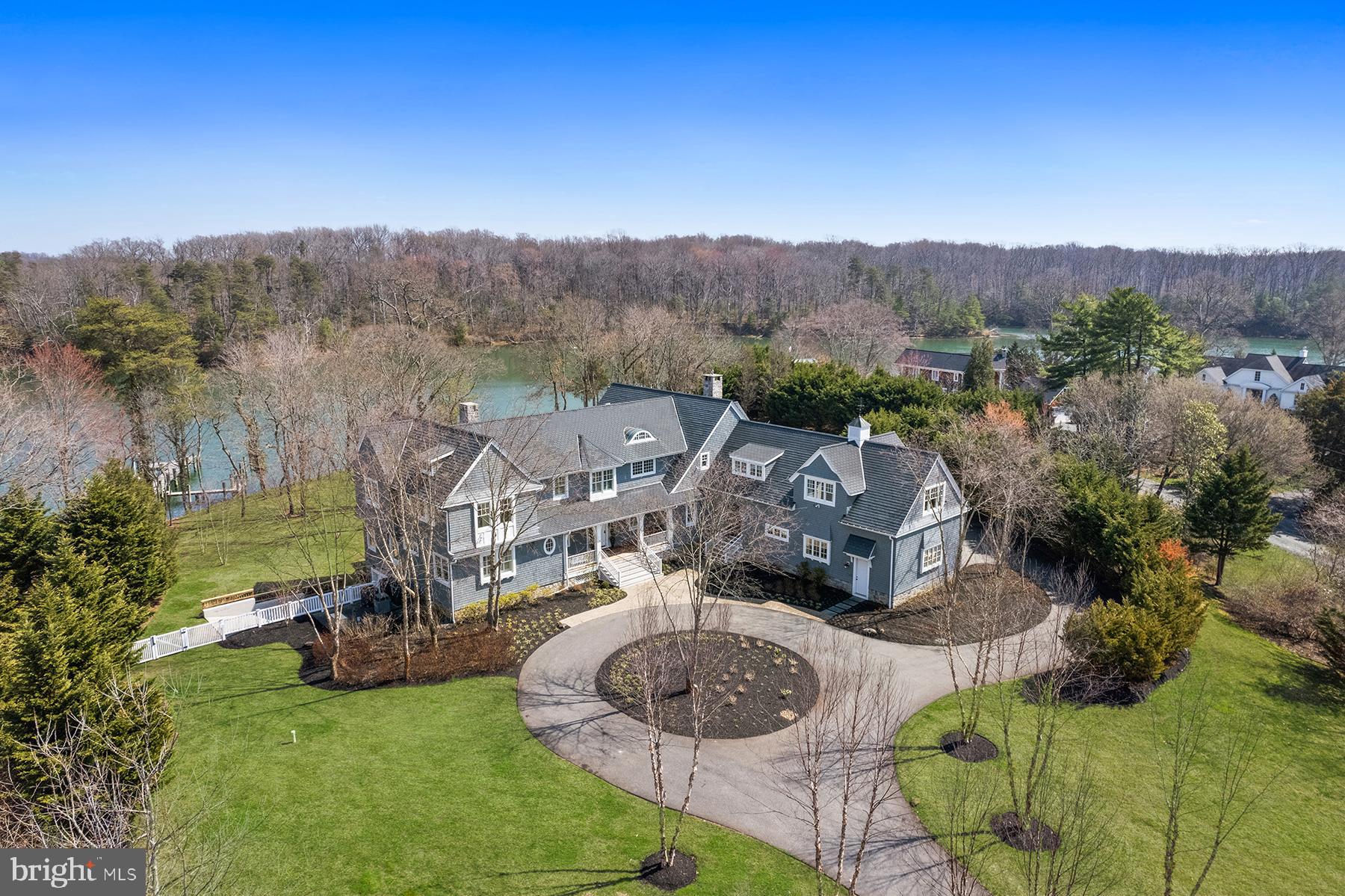 Located on a private 2.5-acre lot in Wimbledon Farms, this waterfront estate home, designed by Cathy Purple Cherry and constructed by West River Builders, is truly a masterpiece in design and quality. The 3-level home – complete with elevator -- takes full advantage of its waterfront setting that includes 400 ft of shoreline. Facing Quiet Waters Park, the ever-changing view includes brilliant fall foliage, deer by the water’s edge, and osprey circling overhead. Stroll down to the 100 ft private pier with deep-water slips. There’s 7 ft water depth at the dock; Harness Creek is a recognized hurricane hole so this is the perfect spot for boats to ride out a storm. The 20 ft x 40 ft saltwater pool has a spacious ipe deck and two Hanso pergolas provide shade with wonderful water views. Six bedrooms, each with a private ensuite bath, a gourmet kitchen, and wrap-around screen porches and decks provide space for both casual living and grand entertaining.

Upon entering, there is a gracious paneled foyer that opens to the living room. With Brazilian cherry floors, a gas fireplace with marble surround, and built-in bookcases, this room has fabulous water views and opens to one of the screened porches on this level that invite outdoor living. To the right is the heart of the home – the great room. It includes a just remodeled chef’s kitchen with multiple work areas, a family room, and the dining area. The kitchen includes Taj Mahal leathered countertops, two wall ovens, two Bosch dishwashers, a warming drawer, instant hot dispenser, Wolf 5-burner gas cooktop, and KitchenAid side-by-side refrigerator. There’s also a wet bar with beverage cooler. The family room has a wood-burning fireplace with raised hearth and stone surround; there’s also a spacious workspace with built-in bookshelves. The dining area overlooks the water, and there’s access to both screened porches. The main level also features a fabulous guest suite: there is a large bedroom with water views, walk-in closet, and a private bath with radiant heated floor. In addition, there are two powder rooms and a mudroom with three closets and an abundance of storage space. The main level has 10 ft ceilings and 8 ft interior doors.
Upstairs, the primary suite is an owner’s dream escape. There’s a spacious bedroom with water views, dark cherry floors and a gas fireplace. The study, with wet bar, built-in shelves and file drawers, leads to a small reading room – with water views. The spa-like bathroom, with radiant heated floor, includes a separate water closet room, jetted tub with marble surround, oversized steam shower, and separate vanities. Step onto the private screened porch to enjoy a cup of coffee in the morning. The primary suite also includes two large walk-in closets and a laundry room. There are three additional water view bedrooms on the second floor, each with private bathroom and walk-in closet. The main laundry is in a dedicated room with ample storage. There’s also a walk-in cedar closet. All of the bedrooms and closets that have carpeting were re-carpeted in 2026.
The walk-out lower level has a huge game room that includes a big screen TV, wet bar, and full bathroom. From here, you can step out to the bluestone patio that leads up to the pool. There is a half-bath off the patio, accessible for pool visitors. The 6th bedroom with ensuite bathroom also has peaceful views, and multiple closets. The main utility room houses the commercial grade water treatment system. It has a garage door for easy access to boat supplies and equipment servicing. A secondary utility room houses the elevator mechanism and reverse osmosis treatment system. A third unfinished area has the camera and internet systems.
This exceptional home offers sophisticated waterfront living just minutes from the heart of Annapolis and the Chesapeake Bay. The year-round beauty of this scenic setting and unrivaled design is truly unsurpassed!