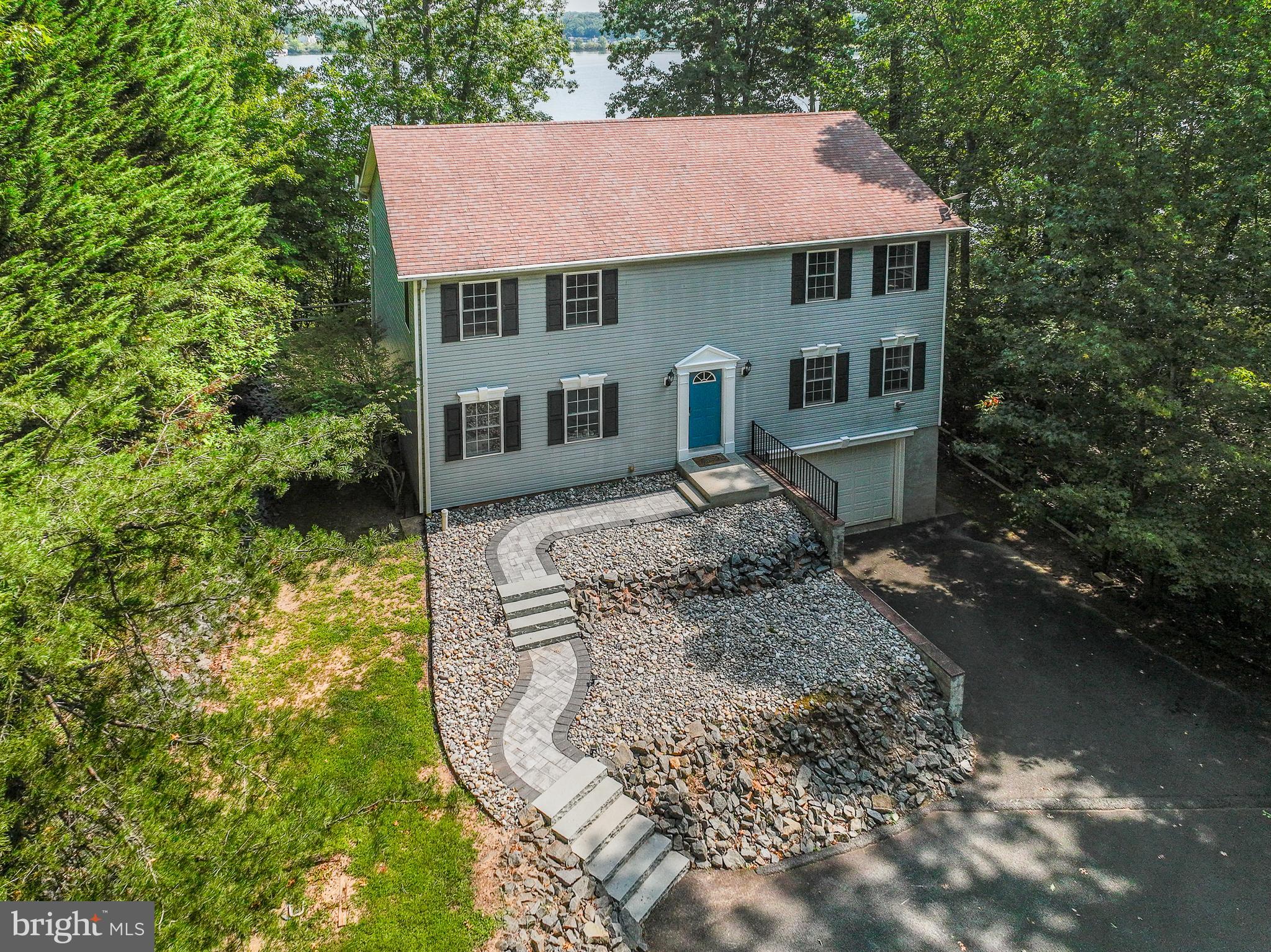 Perched in the highly sought-after Freshwater Estates subdivision on the public side of Lake Anna, this NEWLY RENOVATED and completely furnished waterfront gem combines lakefront tranquility and thoughtful real estate design.  Showcasing tremendous water views and impenetrable privacy, this 3,800+ square foot lakefront enclave is wrapped in lush greenery, and provides 125 feet of pristine waterfront shoreline.  2025 RENOVATIONS: exquisite new granite countertops, deep farmhouse sink, beautiful new flooring, paint throughout the house, remodeled dining room/kitchen, repainted/stained deck, lighting, and more!  Carefully designed across 3 levels, this retreat offers 6 spacious bedrooms, 5 bathrooms, and a living room from which you will experience stress-relieving views of Lake Anna.  The main level features large bedroom suite, a sizable wide-open kitchen, which flows seamlessly into the large living area with propane fireplace and mantle; first level also includes eating area, and separate dining room.  Your guests will enjoy four additional bedrooms upstairs, one with a delightful en suite bathroom featuring large soaking tub, oversized tile shower, and double vanity.  The perfect recreation basement offers a movie area, pool table, foosball, laundry room, upgraded water softener system, bathroom, and large two-car garage with storage shelving.   Take-in your stunning lake views from the massive back deck (just repainted!), and enjoy roasting marshmallows at your stone fire pit, set on a fantastic hardscaped patio.  Lifelong memories will take hold at your private boat house down at the water's edge with deep water, boat slip, electric boat lift, storage room for water toys (paddle board and kayak included), super-fun water slide, and expansive water views.  Investors: short term rentals are permitted in Freshwater Estates; Lake Anna is rated the top location in the nation to own and operate a vacation rental.  Exceptional location, close to groceries and restaurants.