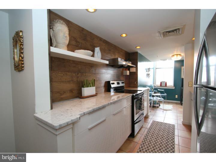 One of the most inspiring and memorable loft units in the Old City Wireworks Building can be yours. The bold and style centric features in this 4th floor 1 bedroom such as an expansive bright and open layout with massive exposed beams and timber ceilings, coupled with the drama of factory size windows... wow! The kitchen has new Euro-inspired flat panel cabinetry, topped by the polished Carara marble counters and a new stainless steel appliance package with stainless range hood will make cooking a luxury experience. We must mention the stunning custom installed back splash that is paired perfectly with the decor & original timber accents. This kitchen is as gorgeous as it is functional with the addition of a pantry closet just off the kitchen. The bath is simply amazing. There is a new bathroom vanity with custom solid wood black walnut counter top and a vessel sink, polished chrome fixtures including the shower and tub. In the large bedroom enjoy a peaceful slumber with new high quality laminate wood flooring, custom closets with built-in shelving and a place and space for everything. All of the windows have been hand fitted with solid wood sills This condo is expertly painted with custom colors including the window trim. There is additional attic craw space storage within the condo, as well as an owner's storage unit in the basement, a common bike storage room, very low condo fees, intercom entrance with security, washer and dryer closet, tree top views, and in walking distance to every Old City venue you love and enjoy.  1 year Parking being included at the Parkomonium at 2nd and Race or nearby parking lot, with an acceptable offer.