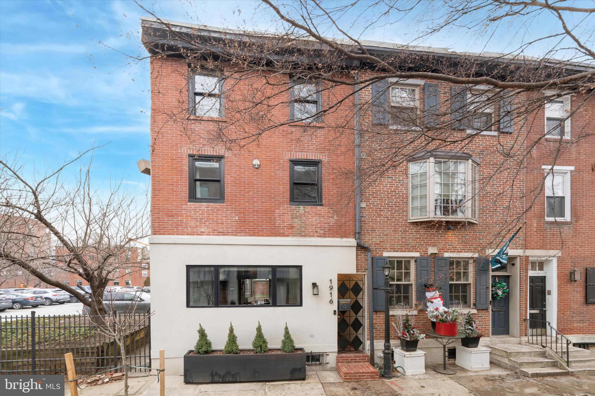 Welcome to 1916 Lombard Street, an exceptional end-of-row home in the highly sought-after Greenfield Elementary catchment, perfectly positioned between Rittenhouse Square and Fitler Square. 

Enter through your private breezeway, thoughtfully designed with a dedicated closet to keep trash, recycling, and daily necessities neatly tucked away yet easily accessible. Inside, the home opens to a bright and inviting dining area, seamlessly connecting the kitchen and living room and setting the tone for easy, everyday living.

The kitchen is both beautiful and functional, offering custom cabinetry with abundant storage, a stunning waterfall quartz island ideal for casual breakfasts or meal prep, and an extra-deep windowsill, perfect for growing herbs year-round. Toward the rear of the home, a well-placed powder room adds convenience, while the living room impresses with built-in storage along the TV wall and a dramatic wall of windows featuring additional seating and hidden storage. 

Step outside to your own private oasis perfect for effortless entertainment complete with a built-in-grill and dining area. The mature tree and low-maintenance artificial turf create a peaceful spot in the heart of the city.

Upstairs on the second floor, you’ll find two generously sized bedrooms, a full hall bath, and conveniently located laundry room. The third floor is truly spectacular, featuring an additional common area, a fully enclosed sunroom, a wet bar, and a serene primary suite with an en-suite bath. The flexible common space works beautifully as a sitting room, office, library, or family room, while the sunroom offers the perfect retreat for morning coffee, workouts, or quiet moments throughout the day.

With the exceptional location of this home close to Rittenhouse Square, Fitler Square, and Avenue of the Arts - all of the wonderful amenities our city offers are at your fingertips.  Shopping, public transportation, entertainment and incredible restaurants are all a short walk away. 

Come see this fantastic home today.