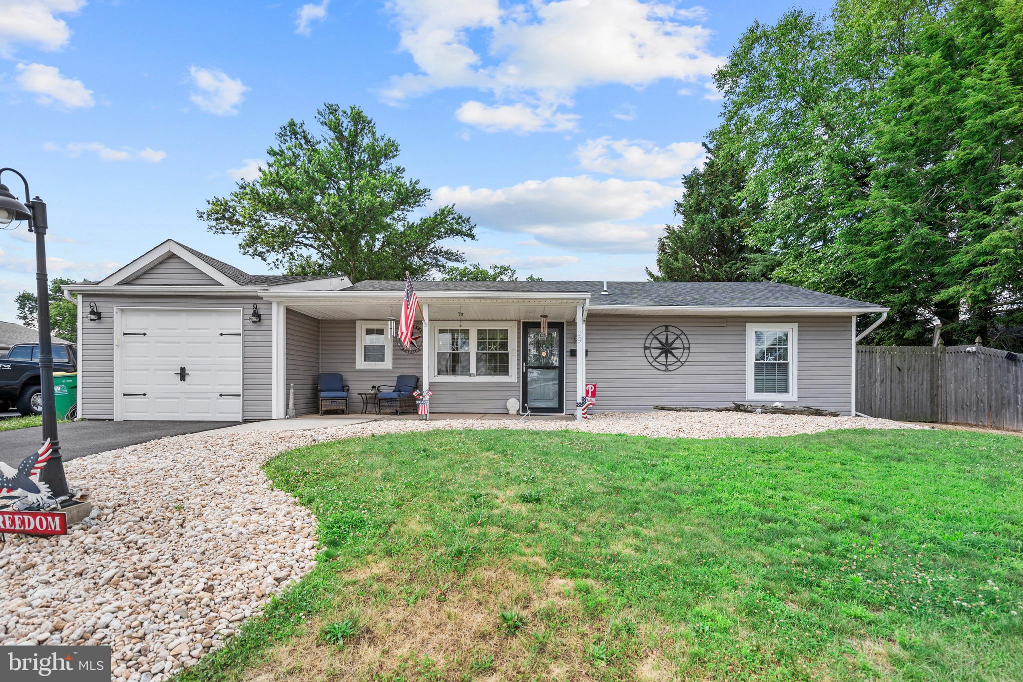 Welcome 29 Favored Lane. Completely transformed and beautifully remodeled in 2019, this stunning Levitt rancher offers the perfect blend of modern style and comfortable living. The open concept floor plan is centered around a gorgeous kitchen featuring a large center island with seating for two ,subway tile backsplash, recessed lighting, and abundant workspace-ideal for everyday living and entertaining. The home offers three spacious bedrooms ,including an expanded primary suite complete with a private ensuite bath and abundance of closet space. A beautifully updated hall bath and convenient powder room provide a total of 2.5 baths. Relax in the cozy family room with a sliding glass door leading to the rear deck-perfect for outdoor gatherings, pets, or play. Additional features include an attached garage, storage shed ,attic storage, economical heat pump with central air and thoughtful updates throughout. Simply unpack and enjoy this truly move in ready home! Call today!