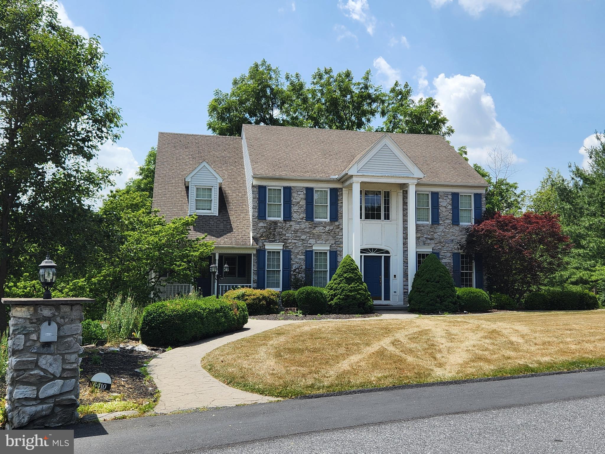 Nestled within the prestigious Huntfield community, this stunning traditional residence offers nearly 4000 square feet of living space within the Central Dauphin School District and Lower Paxton Township. Set on a private, partially wooded 2.75-acre homesite, the property offers peaceful views from the multiple viewing decks and a 12x12 screened porch.  The striking exterior showcases a beautiful stone front, stately Georgian columns, a custom stone mailbox, and a stamped concrete walkway, a charming front porch and a side entry garage.   Step inside to a dramatic two-story foyer filled with natural light. Throughout the home, you'll appreciate soaring 9-foot ceilings & crown molding. The versatile front living room provides the perfect space for a parlor, music room, library, study, or home office, while the formal dining room is designed for entertaining with a tray ceiling, double crown molding, chair rail and French doors. Step into the eat-in kitchen, featuring abundant cabinetry, center island and tile flooring. The kitchen opens seamlessly to the inviting family room where a dramatic floor-to-ceiling stone fireplace provides a warm gathering space. A private den just off the family room offers endless possibilities as a playroom, study, or additional office space. The main level also features a convenient mudroom, laundry room with a secondary entrance leading to the front porch. Upstairs, a secondary staircase leads to four generously sized bedrooms, including a primary suite with vaulted ceilings, a charming Juliet balcony, and double doors opening to an attached bonus room. Perfect as a nursery, sitting room, home office, or dressing room, this flexible space enhances the suite's appeal. Two additional bedrooms share a jack-and-jill bathroom with double vanities and granite countertops, while a third full bathroom conveniently serves the remaining bedroom. The finished walkout lower level offers exceptional flexibility with additional living space, a fifth bedroom, and a bonus room ideal for gym, hobby room, or guest accommodations.  An unfinished area with shelving provides abundant storage space. Additional highlights include an oversized two-car garage with workbench, additional driveway parking and energy-efficient geothermal heating.  The unique 2.75-acre property offers the best of both worlds-open grassy area for recreation, along with mature, wooded surroundings and that provide privacy and tranquility. 

 Schedule your private showing today