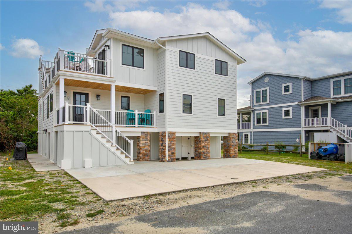 WOWZA!!!!!!    Welcome to your ocean block coastal dream retreat  that promises the ultimate beachside lifestyle.  This home has been completely renovated and shows like a model home! The entry level offers the first of 3 living areas.  The ground level living area is a perfect space for you to kick back on the comfy sofa & watch  a movie  or play ping pong !   The second level includes 4 bedrooms & 4 bath,  2nd living area, and laundry room.  Finally, the third floor has your spacious king ensuite master including a second laundry room & deck. The kitchen is equipped with stainless steel appliances,  wine frig, custom cabinetry, tile backsplash and ample counter space for culinary creations. An adjacent dining area sets the stage for memorable family meals and gatherings with friends.  Multiple living areas offer plenty of space for entertaining and unwinding.  Sip your morning coffee/Happy Hour beverages on  the main deck or on the  "crows nest deck"  while enjoying the views of the ocean.  New furniture,  upgraded bathrooms with beautiful tile & luxury flooring throughout the home, 2 outside showers and all just steps from the beach!