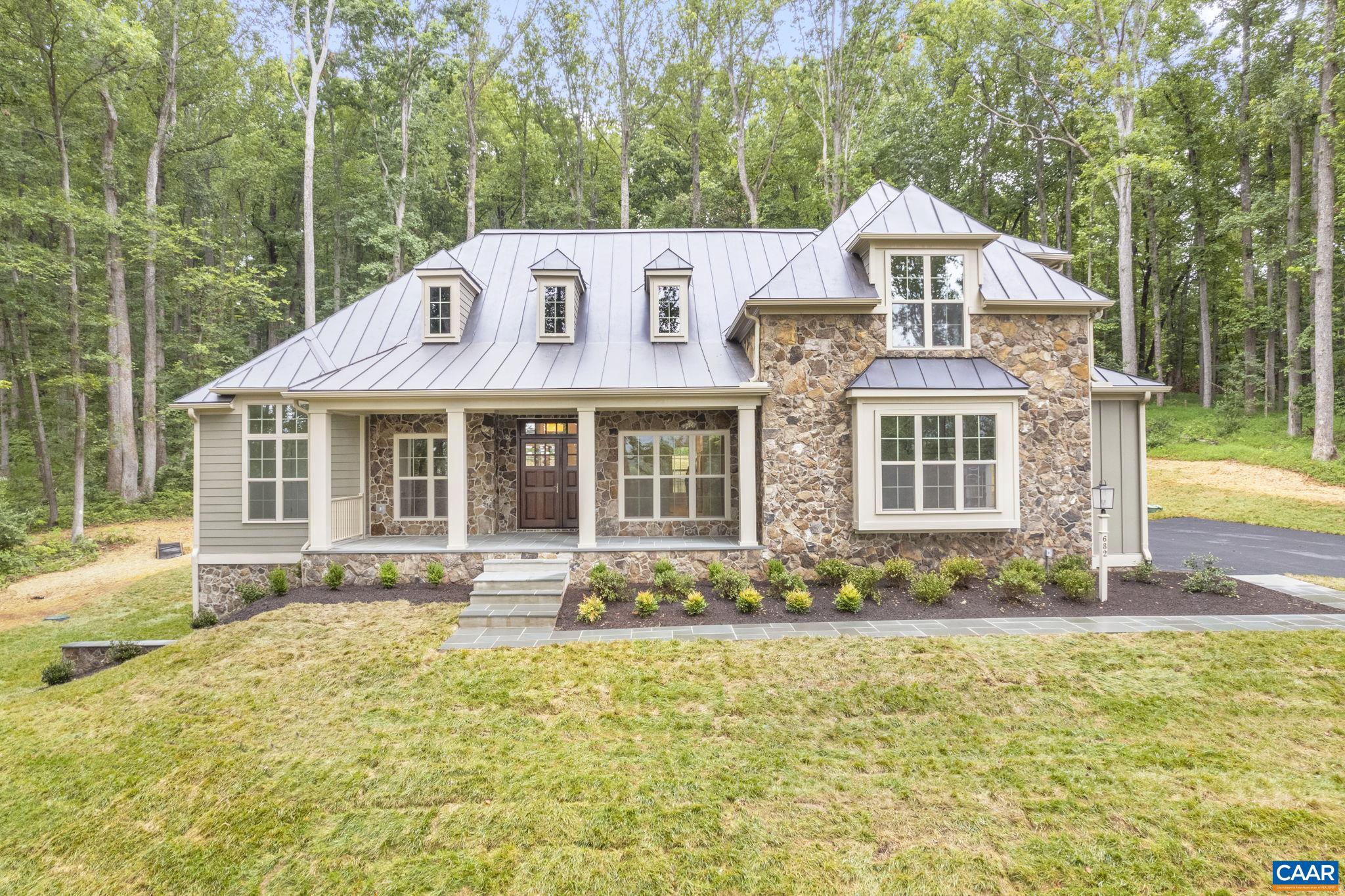 Pre-Sale Newport with August 2025 Closing. Unique offering in this premier, established community on a wooded, 5 acre homesite, convenient to UVA and downtown. This ?Newport? plan offers an open floorplan with a stunning Great Room that boasts a cathedral ceiling and tons of windows to maximize natural light. Walkout basement with finished basement recreation room & full bath included. Quality built 2�6 exterior walls, custom mahogany front door, R-19 insulation, and standing seam metal roof. Kitchen includes painted maple cabinetry (white, gray, etc. shaker style), granite countertops (also in primary suite), and much more. Photos are of previously built model home. New Construction with no construction loan needed? with deposit Builder will fund the build so that purchaser may obtain the same type of loan as if they bought a resale. Builder also offers a streamlined process to make planning your move easy with a known move in date upfront. On-staff draftsman for plan customizations.,Granite Counter,Maple Cabinets,Painted Cabinets,White Cabinets,Fireplace in Family Room