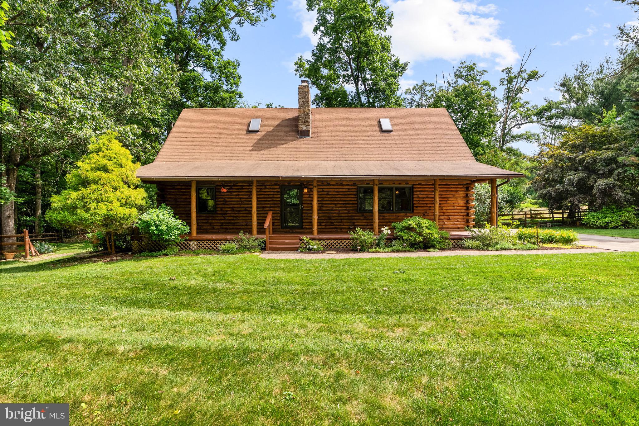 Nestled on a private and picturesque lot in Sykesville, this one-of-a-kind log cabin offers the perfect blend of rustic charm and modern comfort. Surrounded by nature and thoughtfully updated, the home welcomes you with soaring wood-beamed ceilings and warm timber finishes. The finished lower level provides valuable additional living space perfect for a recreation room, home office, gym, or guest retreat. Whether you're enjoying your morning coffee on the porch, gathering around the expansive stone fireplace, or taking in the peaceful views from the deck out back, every corner of this property offers a sense of serenity. A rare opportunity to own a true log home with character, privacy, and timeless appeal. Conveniently located near shopping, dining, and commuter routes.