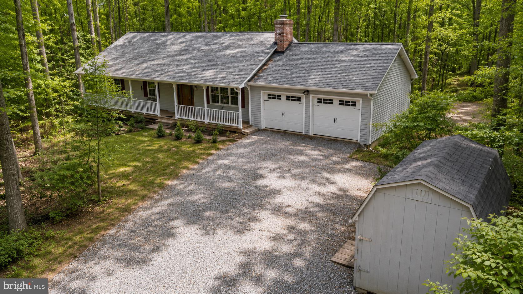 **Catered Open House this Friday (7/10) 6-8pm,  Saturday (7/11) 1-3pm and Sunday (7/12) 1-3pm** 

Living’s More Fun With This Much Privacy

Nestled beneath mature hardwoods on a beautifully wooded 1.28-acre homesite, this inviting ranch offers the peace and privacy of country living without sacrificing convenience. Set well back from the road, the property feels like a private retreat where every season brings a new backdrop of color and natural beauty.

A welcoming covered front porch stretches across the front of the home, creating the perfect place to enjoy morning coffee, summer evenings, or the peaceful sounds of nature. Inside, hardwood flooring, abundant natural light, and warm finishes create an atmosphere that feels instantly comfortable.

Vaulted ceilings in both the kitchen and living room enhance the home’s open feel, while skylights in the kitchen fill both spaces with natural light. The kitchen features an island, generous cabinetry, and plenty of room for everyday living. In the living room, a wood stove set against an impressive two-story brick surround creates a striking focal point and cozy gathering space.

The main level includes three bedrooms and two full baths, including a primary suite with private bath and access to the rear deck overlooking the wooded setting. The finished walkout lower level adds valuable flexibility with additional living space, a fourth bedroom, full bath, and a standalone wood stove.

 Surrounded by mature hardwoods, lush greenery, and seasonal blooms, the setting feels like a serene woodland retreat. Throughout the spring and summer months, vibrant azaleas add bursts of color across the landscape. The rear deck and patio overlook this private natural setting, while the 1.28-acre homesite provides room to spread out, entertain, enjoy outdoor projects, or simply appreciate the beauty of the surrounding landscape. Two sheds provide valuable storage space for tools, equipment, and seasonal items, while the attached two-car garage adds everyday convenience and even more storage.

Thoughtful improvements include a heat pump, well pump, expansion tank, hot water heater, water treatment system with reverse osmosis, washer, dryer, garage doors, and ultra-quiet garage door openers. Quality 2x6 construction adds durability and efficiency.

Located in Shenandoah Estates, this property offers 2,520 finished square feet and a rare opportunity to enjoy space, privacy, and natural surroundings in a setting that truly feels away from it all while remaining convenient to everyday necessities.